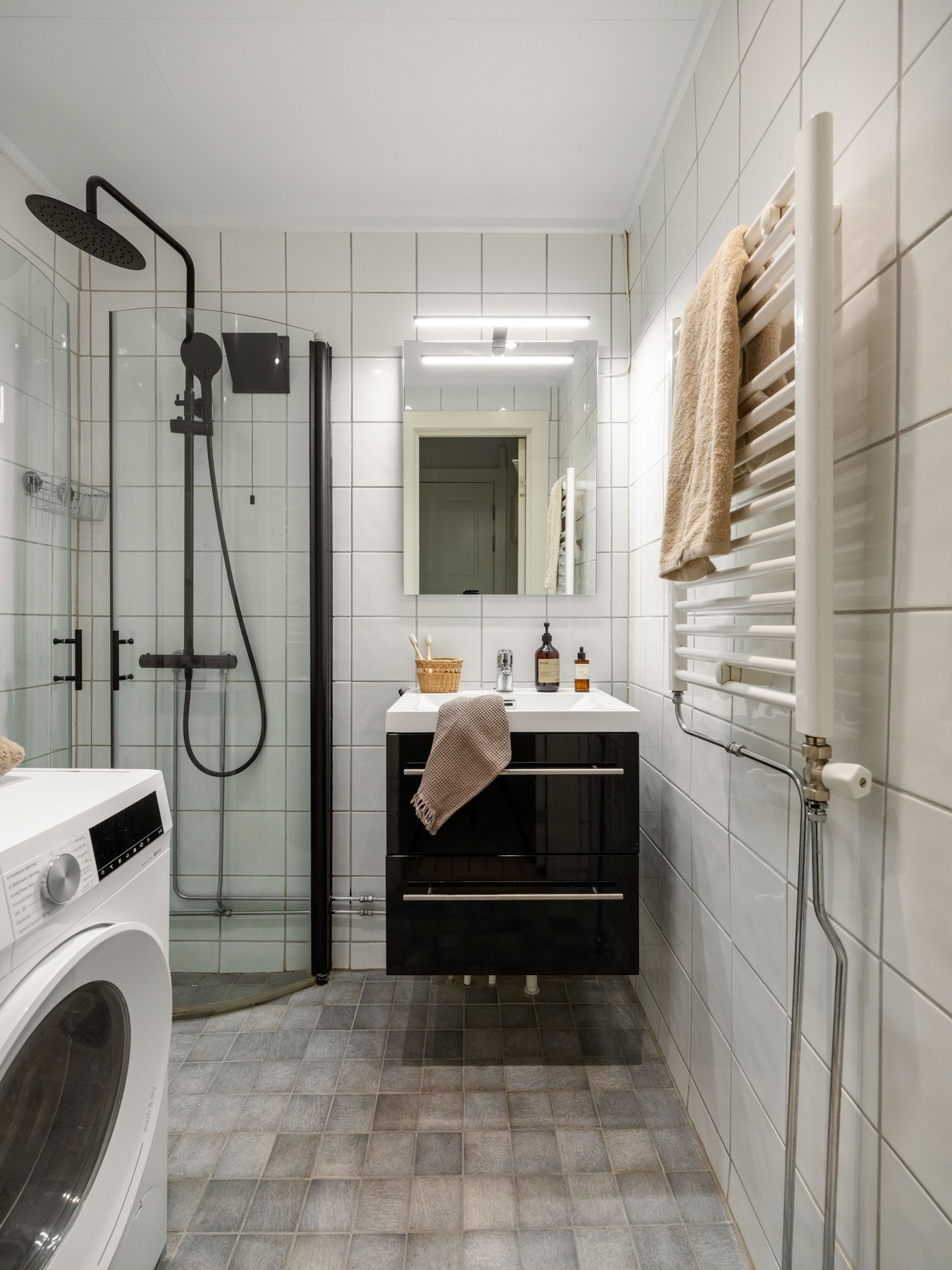 Fra entréen ligger dusjbadet fra 2007. Det er innredet med regnfallsdusj, vegghengt servant med skapinnredning og speil. Galleribilde