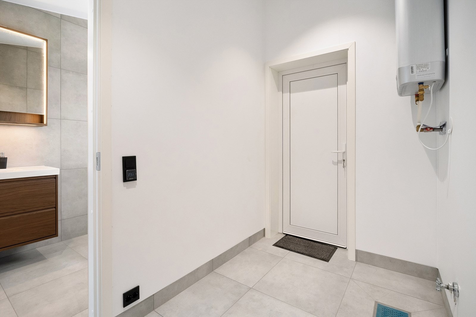 Teknisk rom med opplegg for vaskemaskin og plass til oppbevaring. Galleribilde