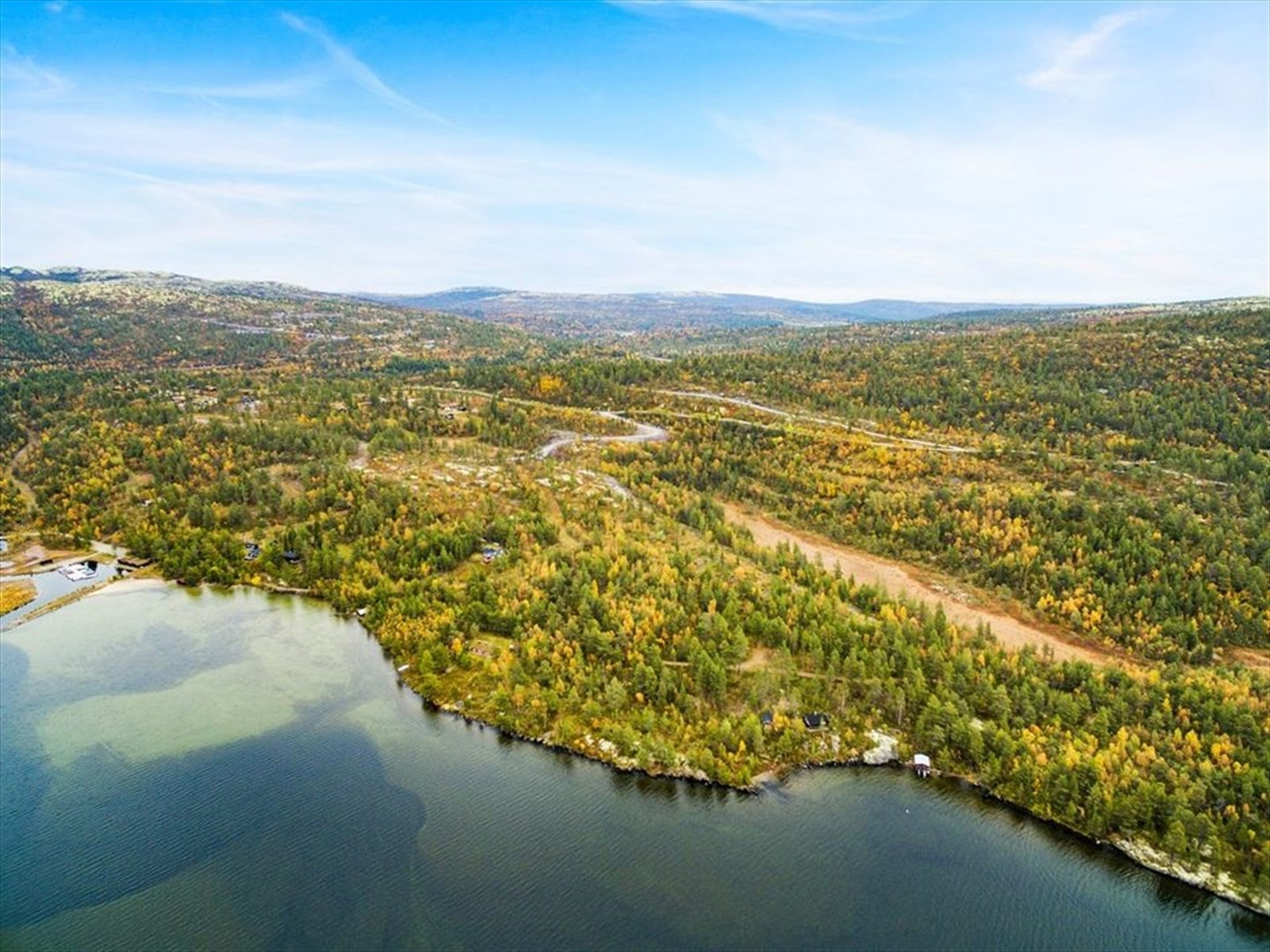 Dronefoto mot tomtefelt fra sjøen.jpg Galleribilde