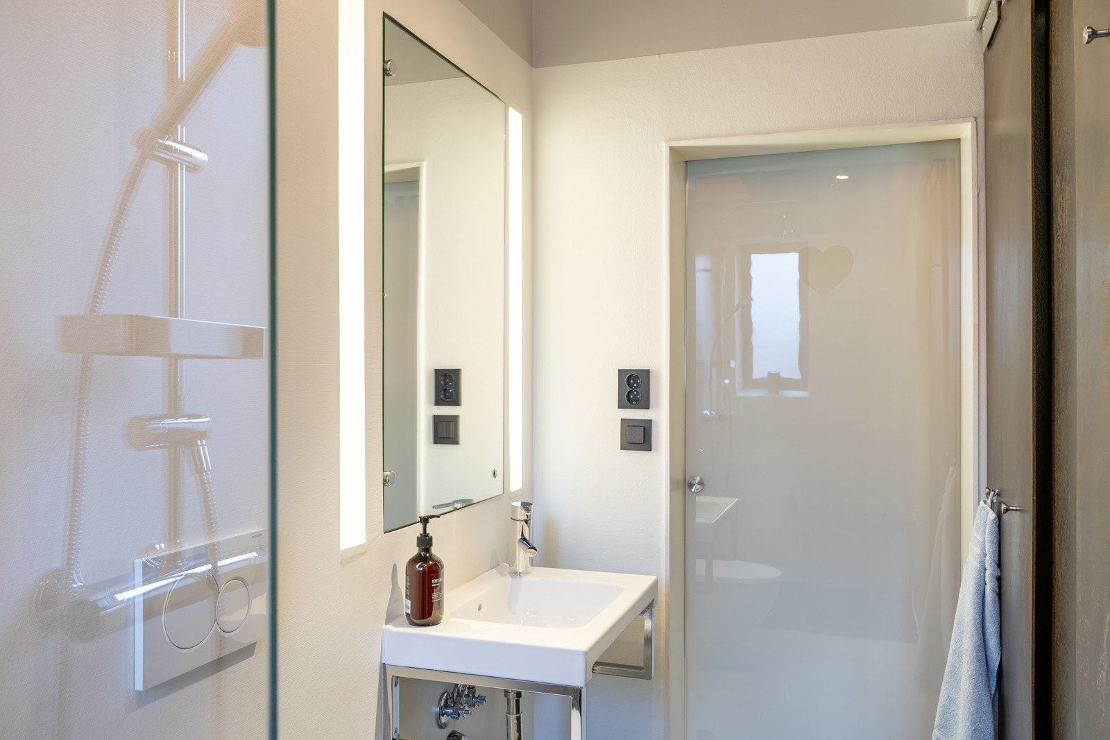 Pent bad med elegante løsninger som automatisk frosting av baderomsdør. Teknisk rom finnes bak ståldørene på badet. Galleribilde