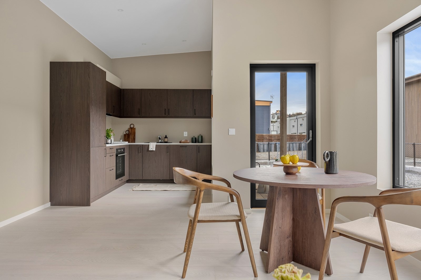 Mellom stue og kjøkken er det god plass til å innrede med spisebord for hyggelige sammenkomster. Galleribilde