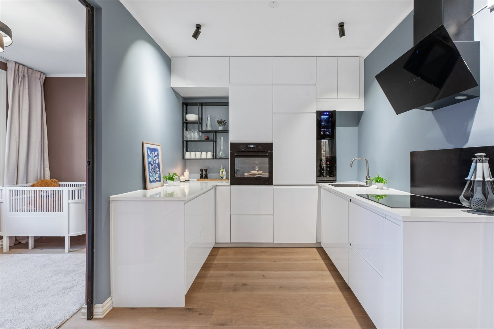 Hvitevarer som kjøl/fryseskap, oppvaskmaskin, induksjonstopp, vinskap og stekeovn er inntegrert i innredningen. Galleribilde