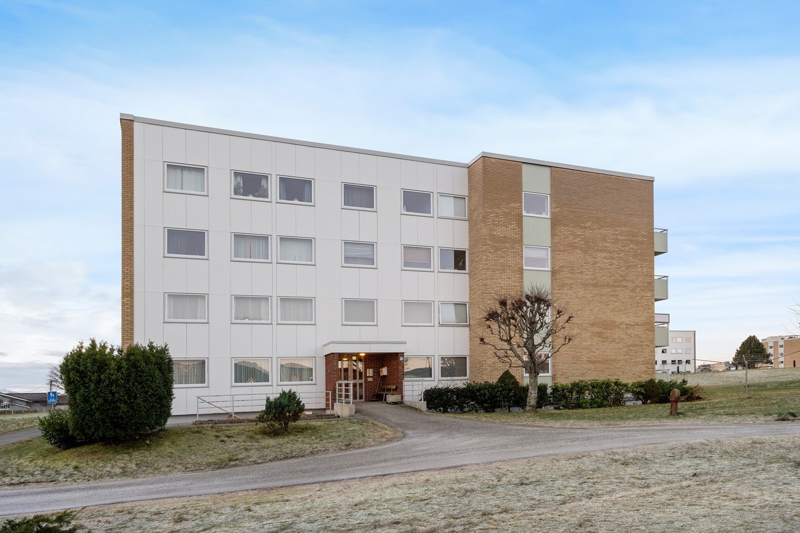 Inngangspartiet er pent opparbeidet med adkomst via asfaltert gangvei. Galleribilde