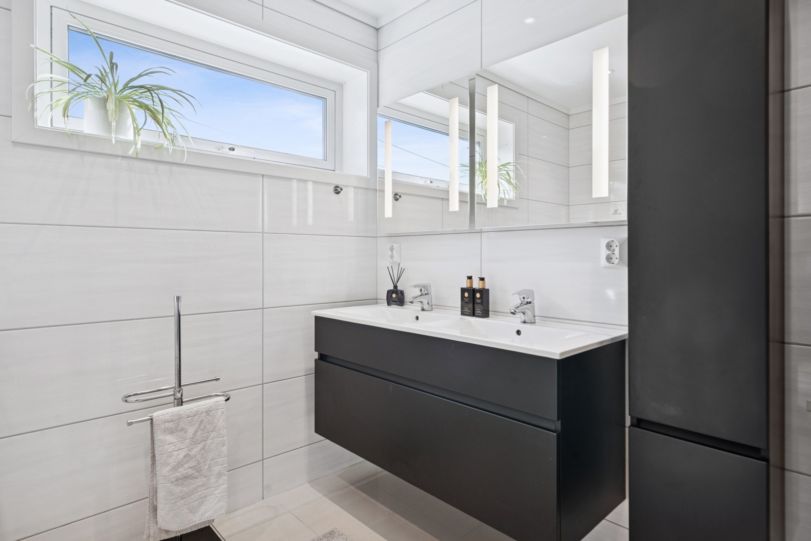 Det har to vegghengte speil med lys og to høyskap fra Hafa Bad. Galleribilde