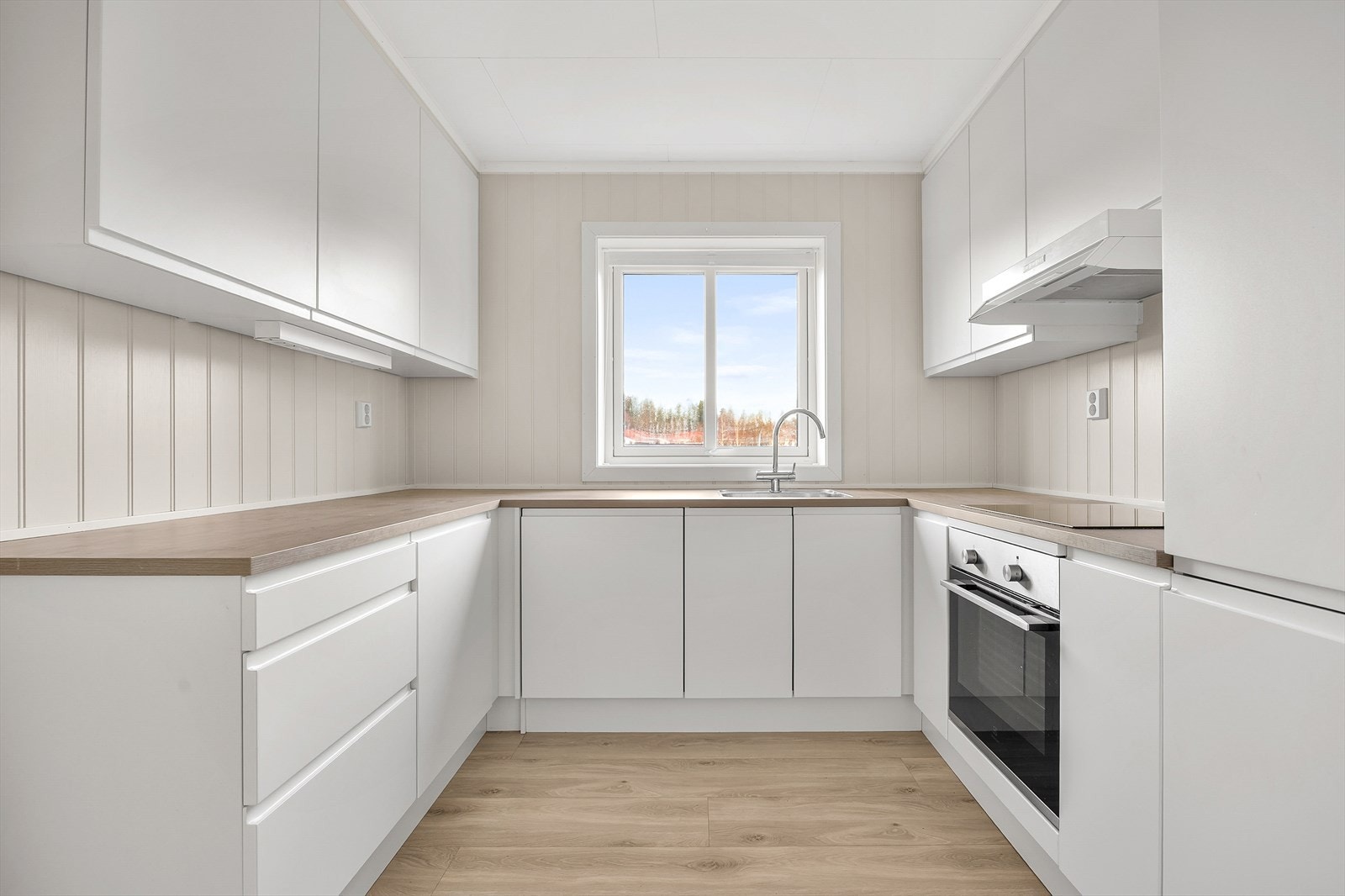 Kjøkkenet har en praktisk U-form med gode arbeidsflater og rikelig med skapplass. Galleribilde