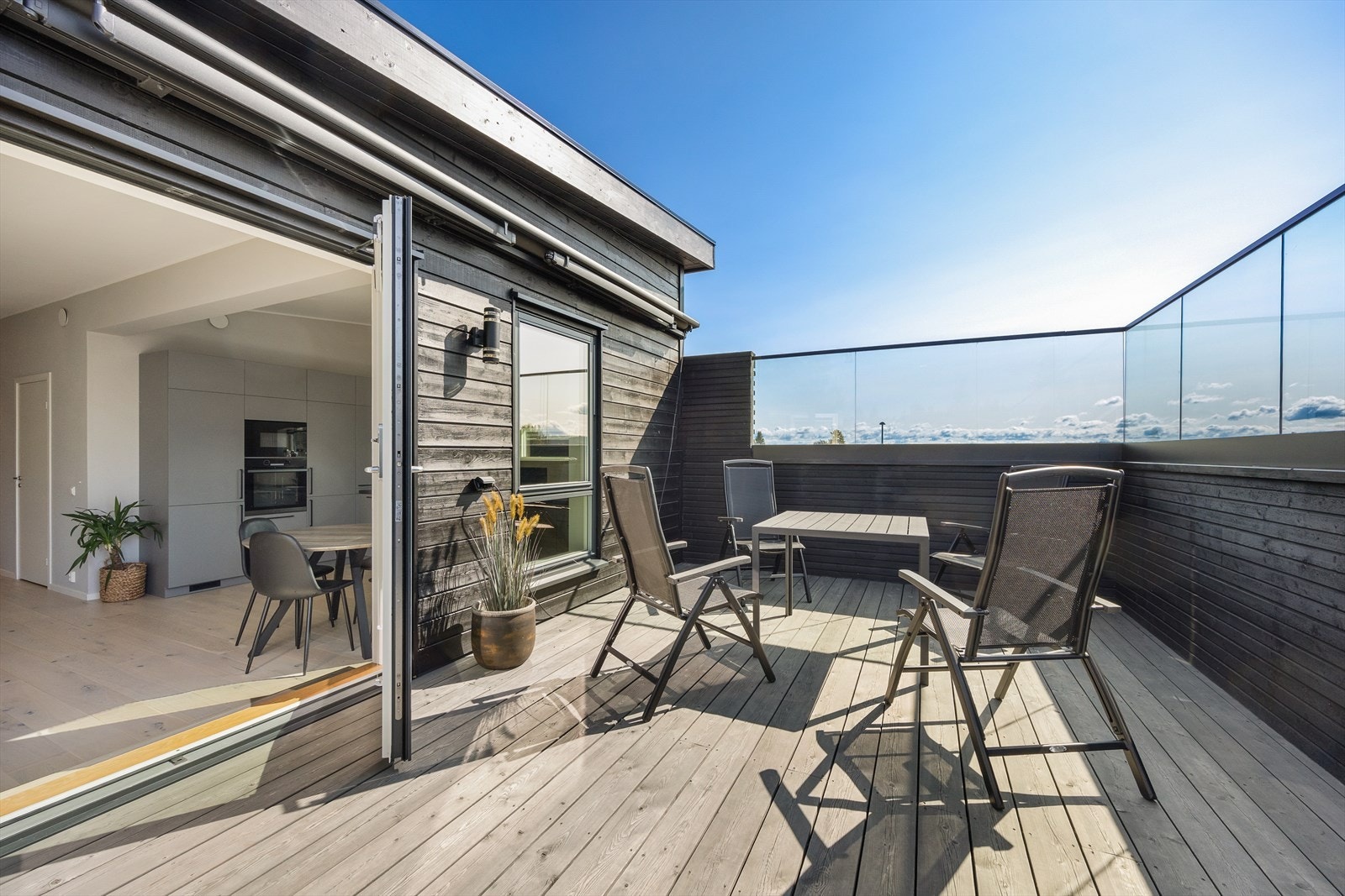 Terrasse på 29m² med impregnerte gulvbord og glassrekkverk - perfekt for sommerdager. Galleribilde