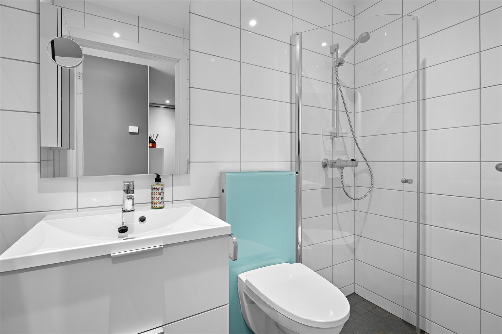 Det andre badet har adkomst fra gangen og er utstyrt med servantinnredning, toalett og dusjhjørne. Galleribilde