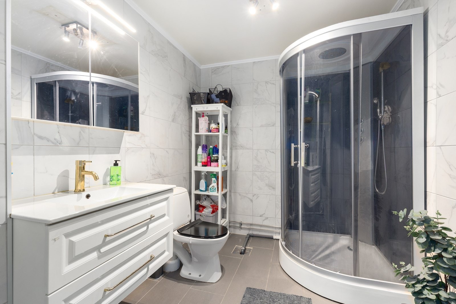 Helfliset bad i underetasjen som er pusset opp i 2024 og har varmekabler i gulvet. Her er det god oppbevaringsplass i innredning med dype skuffer og heldekkende servant, samt i speilskap med overlys. Galleribilde