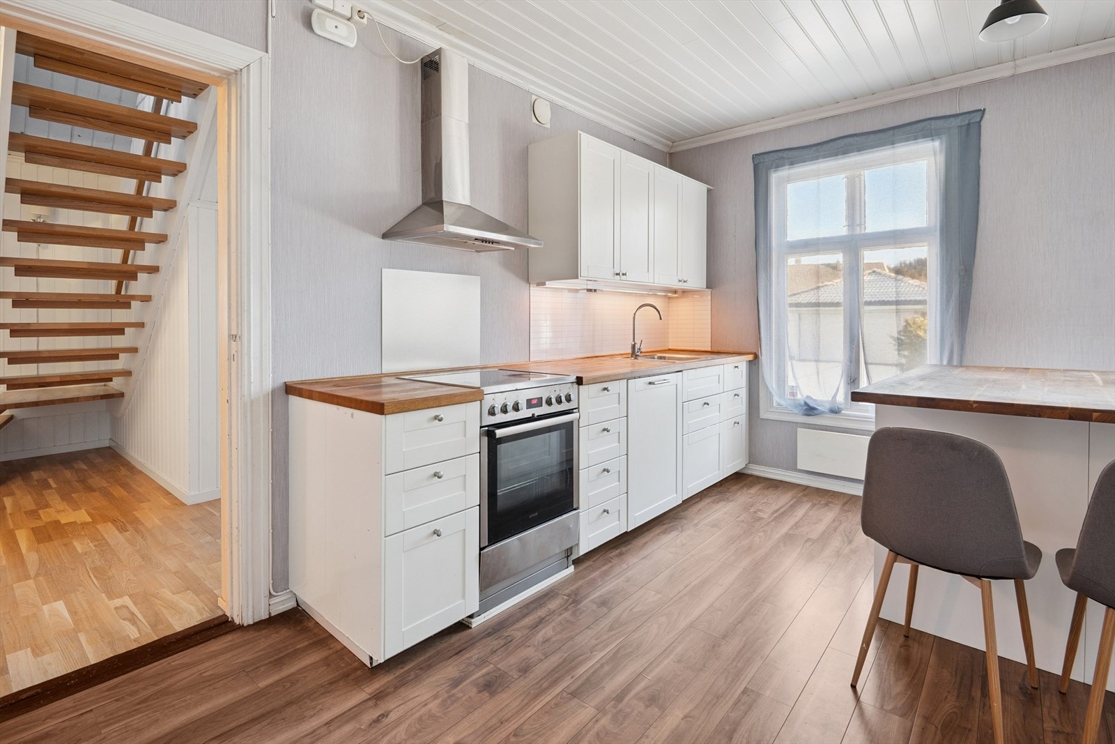 Kjøkkenet har innredning med profilerte fronter og en benkeplate i heltre. Galleribilde