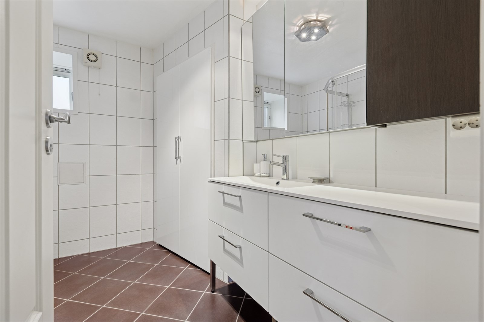 Badet er lyst og arealeffektivt, med baderomsinnredning som gir ekstra benke- og oppbevaringsplass. Galleribilde