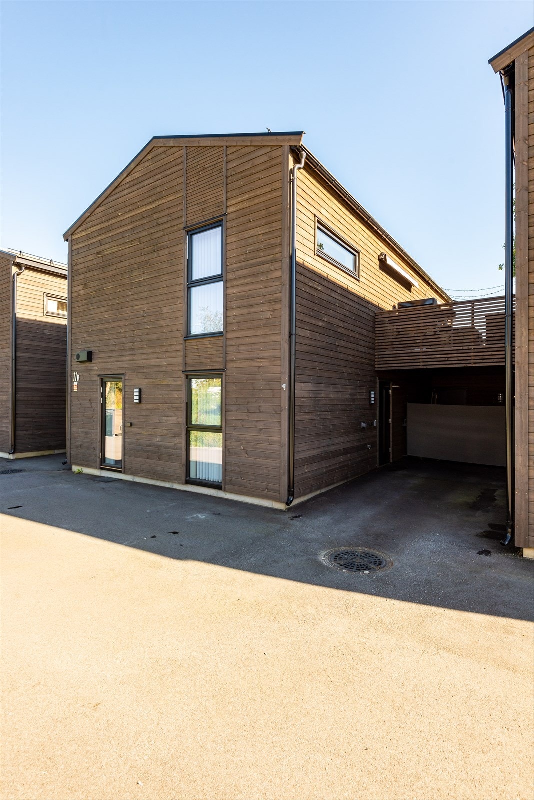 Asfaltert innkjørsel gir plass til parkering ved inngangspartiet. Galleribilde