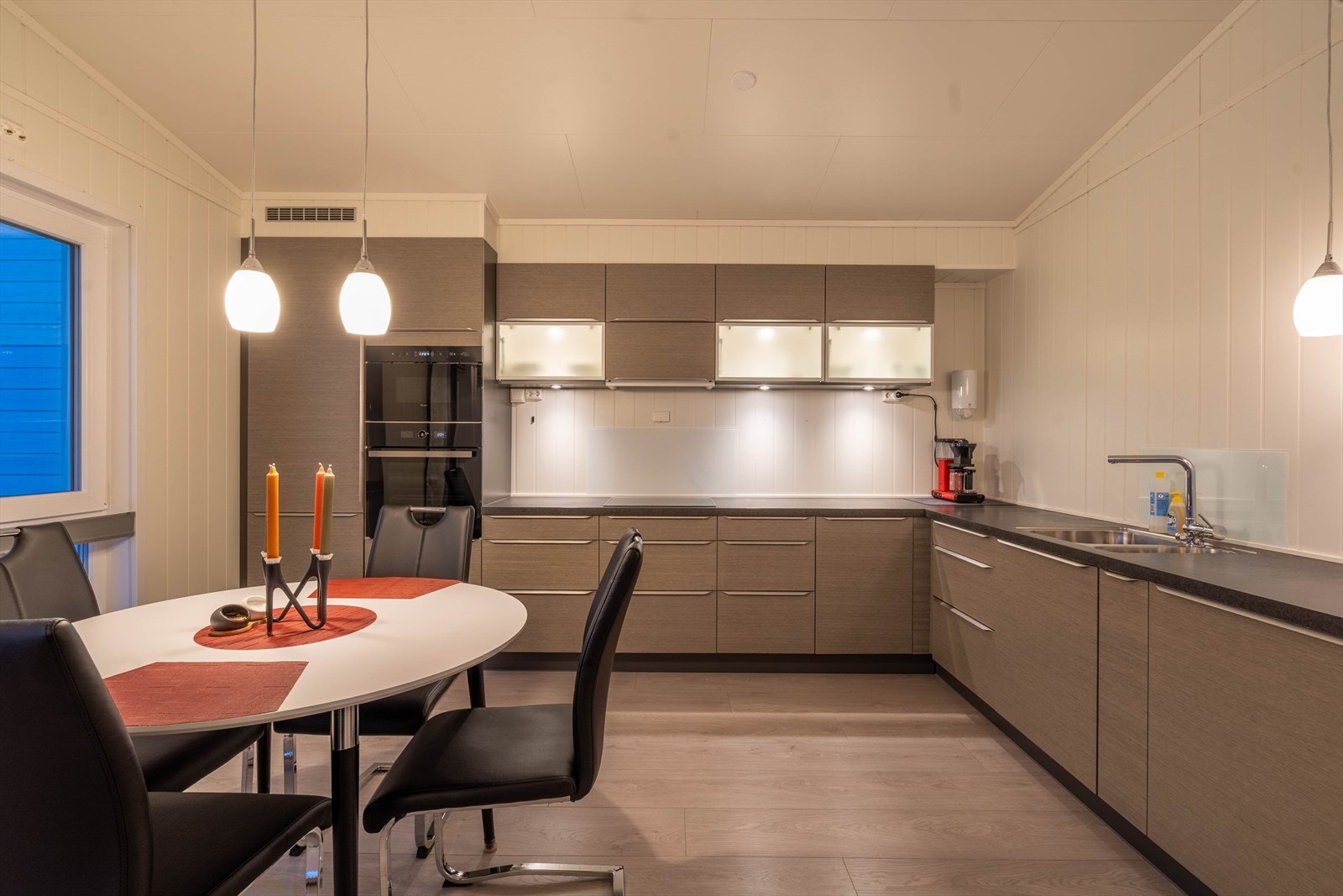 Moderne kjøkken med stilren innredning, godt lys og romslig benkeplass. Perfekt for matlaging og sosiale sammenkomster. Galleribilde