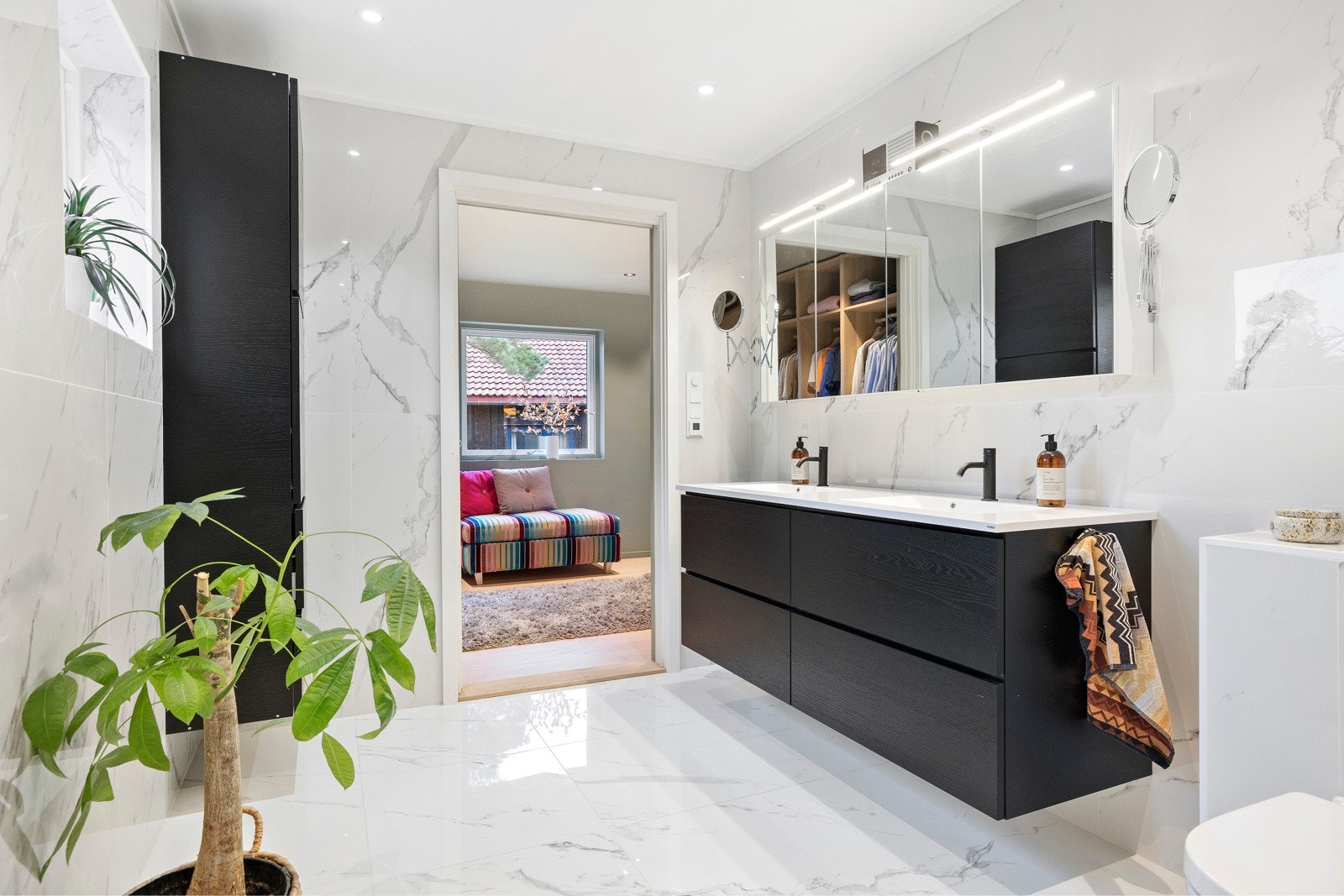 Bad i begge etasjer er renovert av fagfolk i 2023. Dette badet har marmorerte fliser i storformat på gulv og vegger. Galleribilde