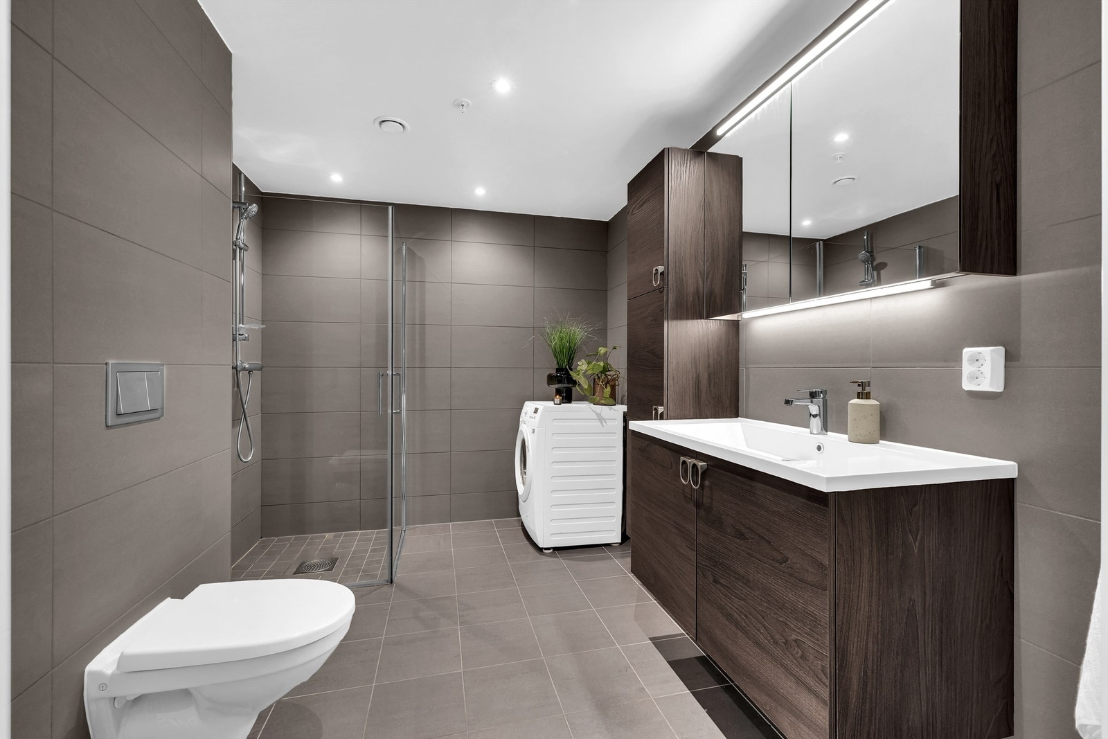 Baderom 1 fra byggeår med flislagt gulv med gulvvarme og flislagte vegger Galleribilde