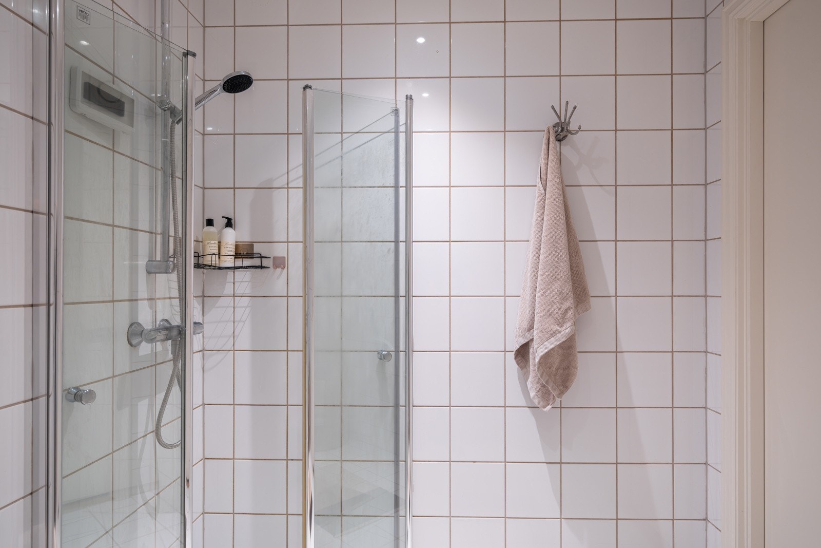 Baderommet har lyse fliser på gulv og vegger, vannbåren gulvvarme, downlights i himlingen og avtrekk via balansert ventilasjon. Galleribilde