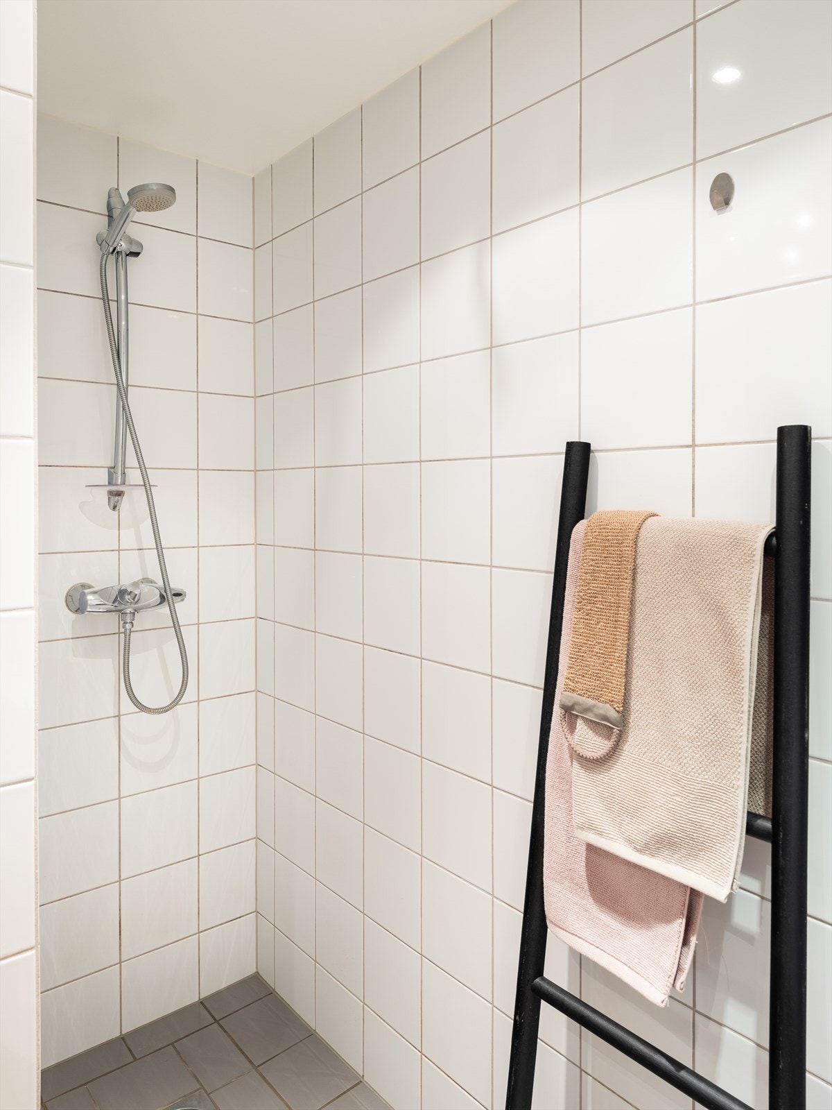 Badet er utstyrt med servant, dusjnisje, veggmontert WC og opplegg for vaskemaskin. Galleribilde