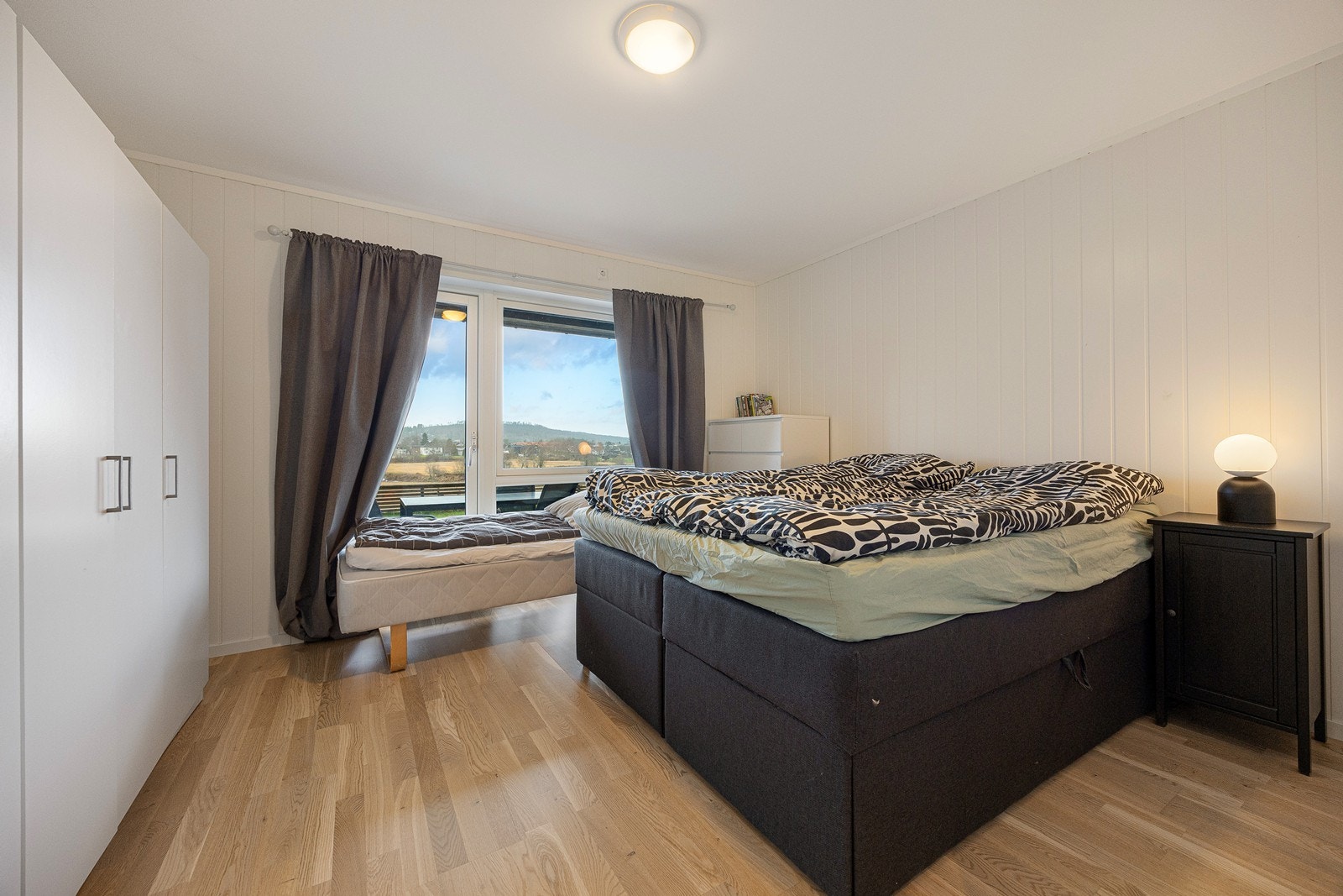 Hovedsoverommet er romslig og har god plass til både dobbeltseng og annet møblement. Det er direkte utgang til den solrike markterrassen, og rommet har god oppbevaringsplass i et hvitt garderobeskap. Galleribilde