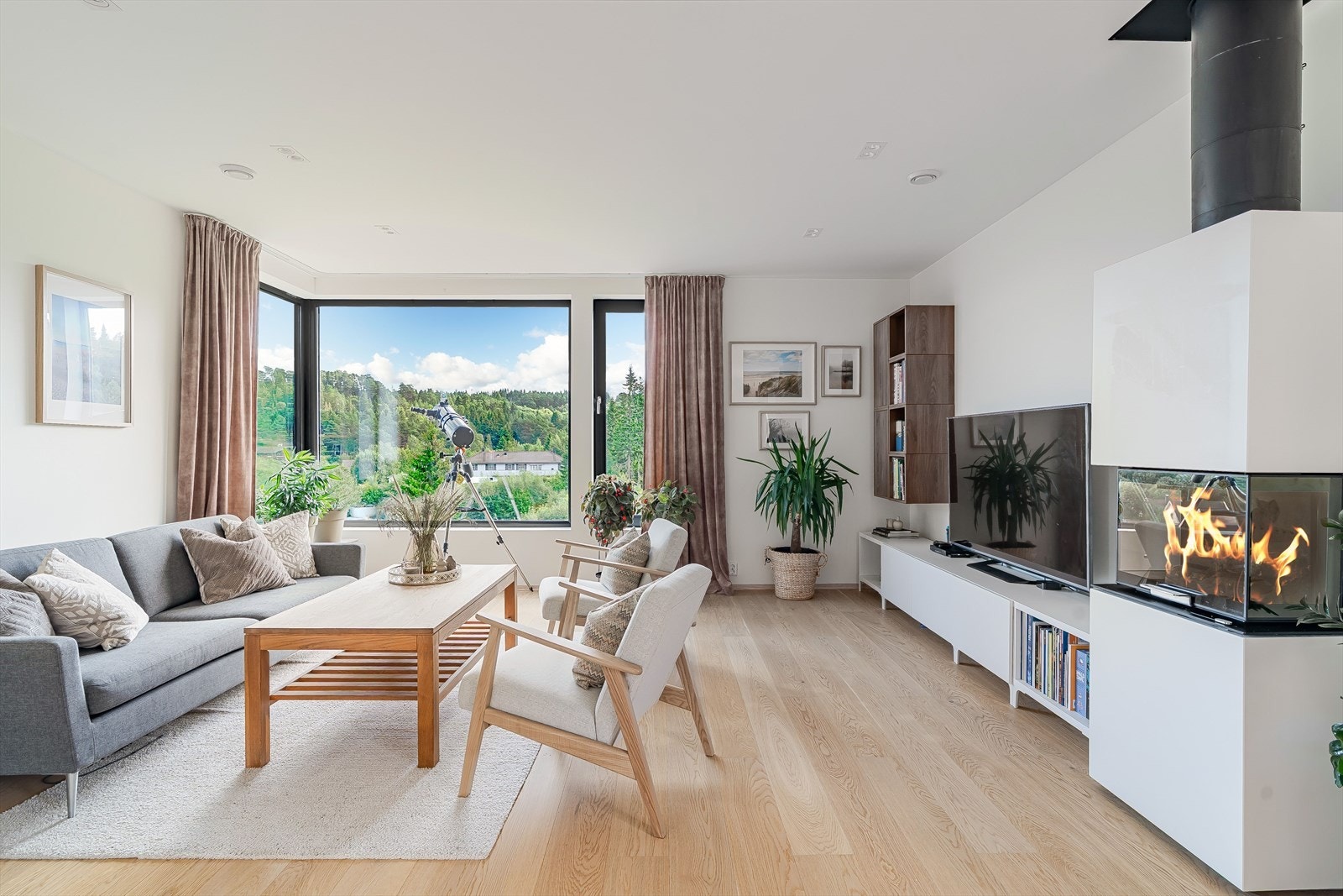 Luftig stue med store hjørnevinduer, peisovn og plass til god sittegruppe. Galleribilde