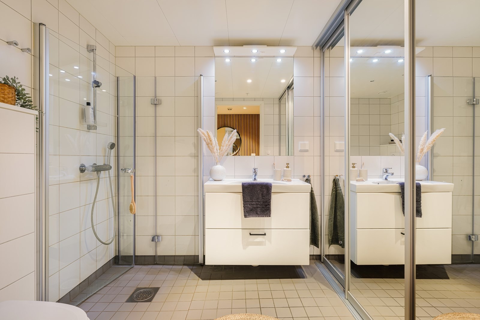 Badet har lyse fliser, vannbåren varme i gulvet og dusjhjørne med innfellbare dusjvegger Galleribilde