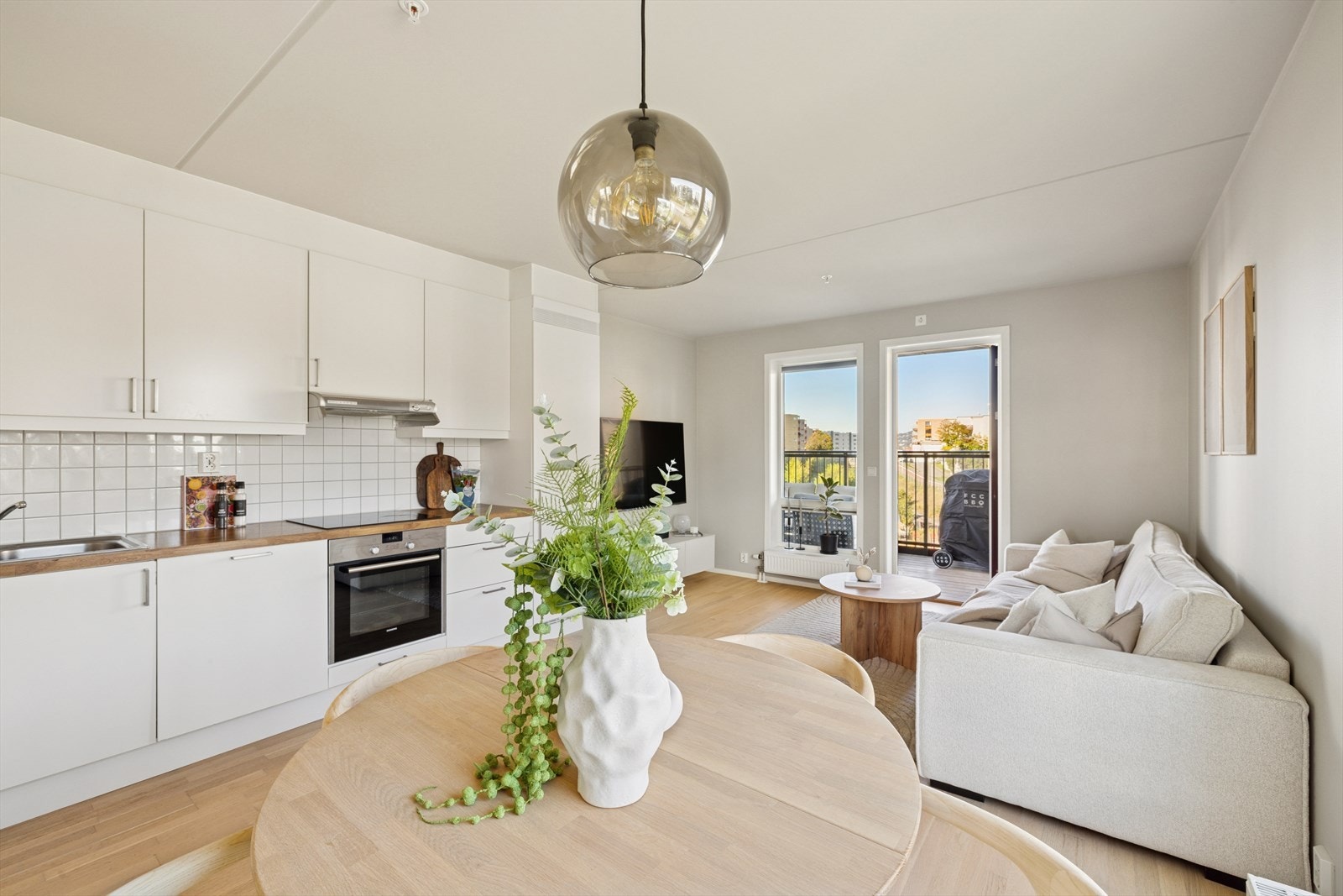 Stuen og kjøkkenet ligger i åpen løsning og har gulv av parkett og malte hvite vegger. Galleribilde