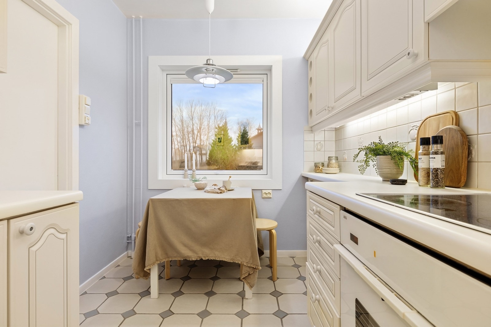 God plass til et hyggelig spisebord langs vindu Galleribilde