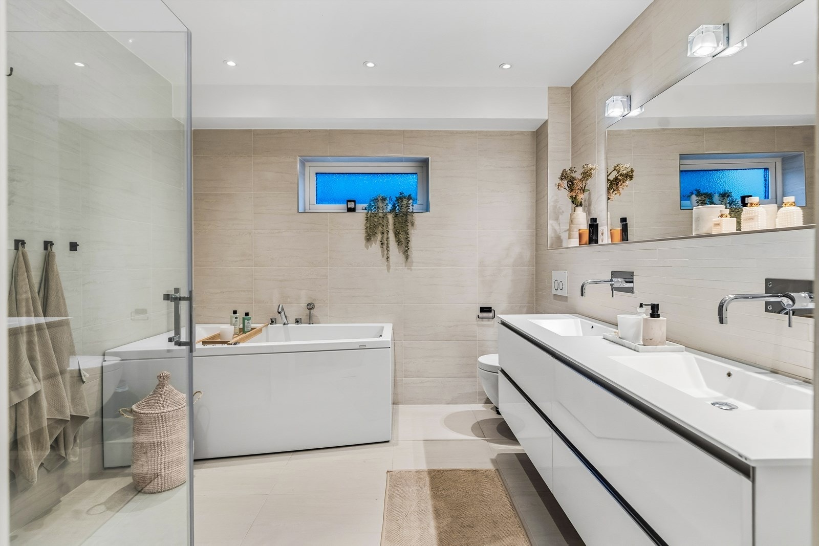 Stort baderom med dobbel servant og romslig innredning. Galleribilde