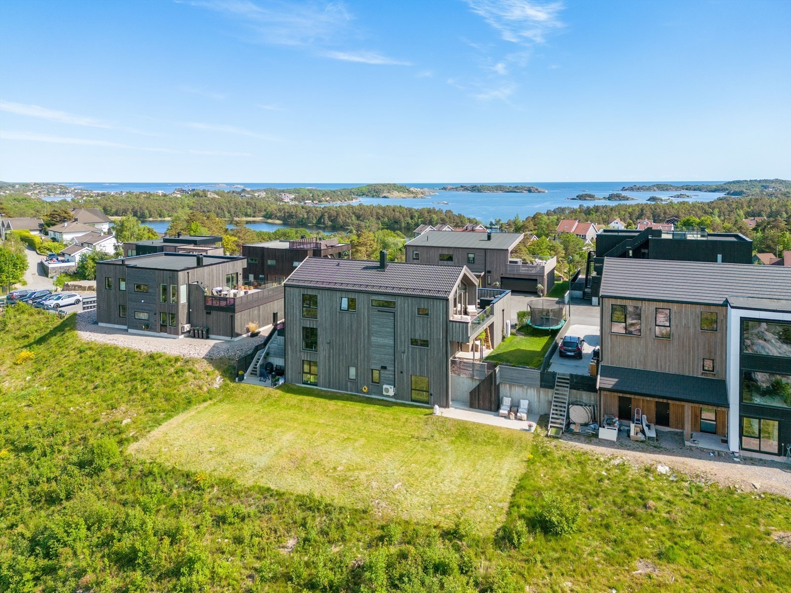 Den store gressplenen i bilde er ikke en del av boligen, men eier ønsker den vedlikeholdt. Galleribilde