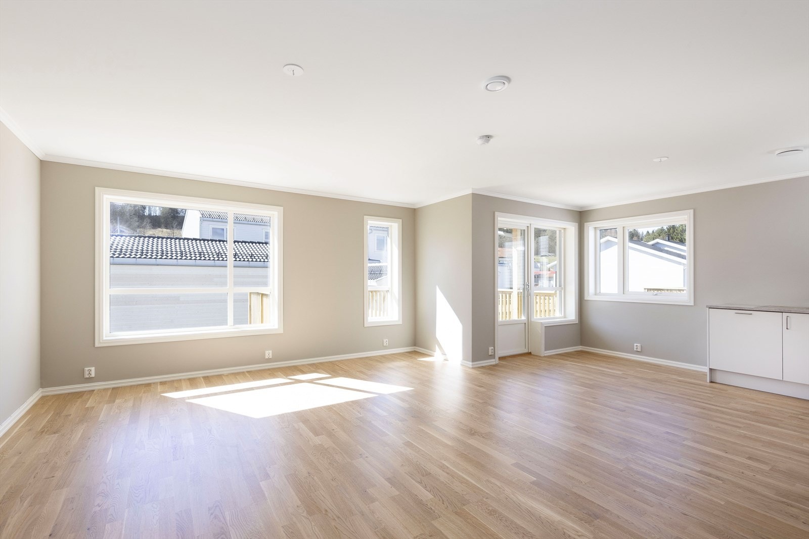 Romslig stue med store vinduer som slipper inn godt med lys Galleribilde