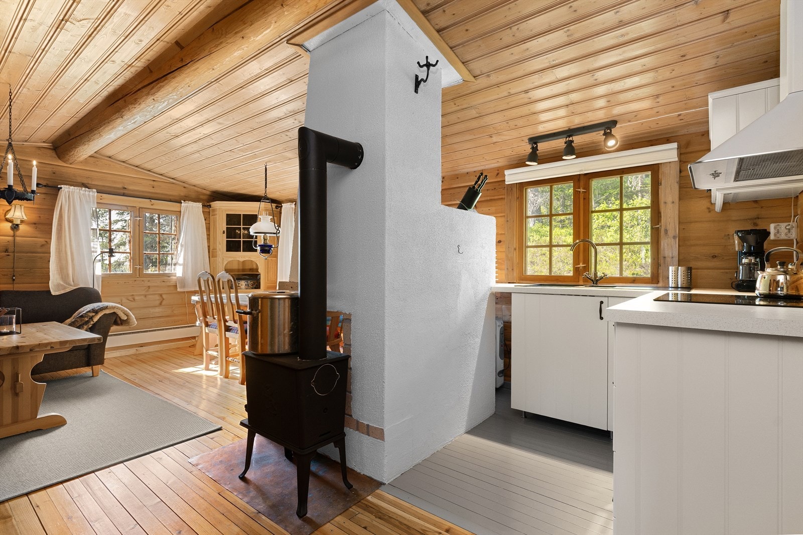 Stuen har furugulv og maskin laftet tømmer på vegg. Galleribilde