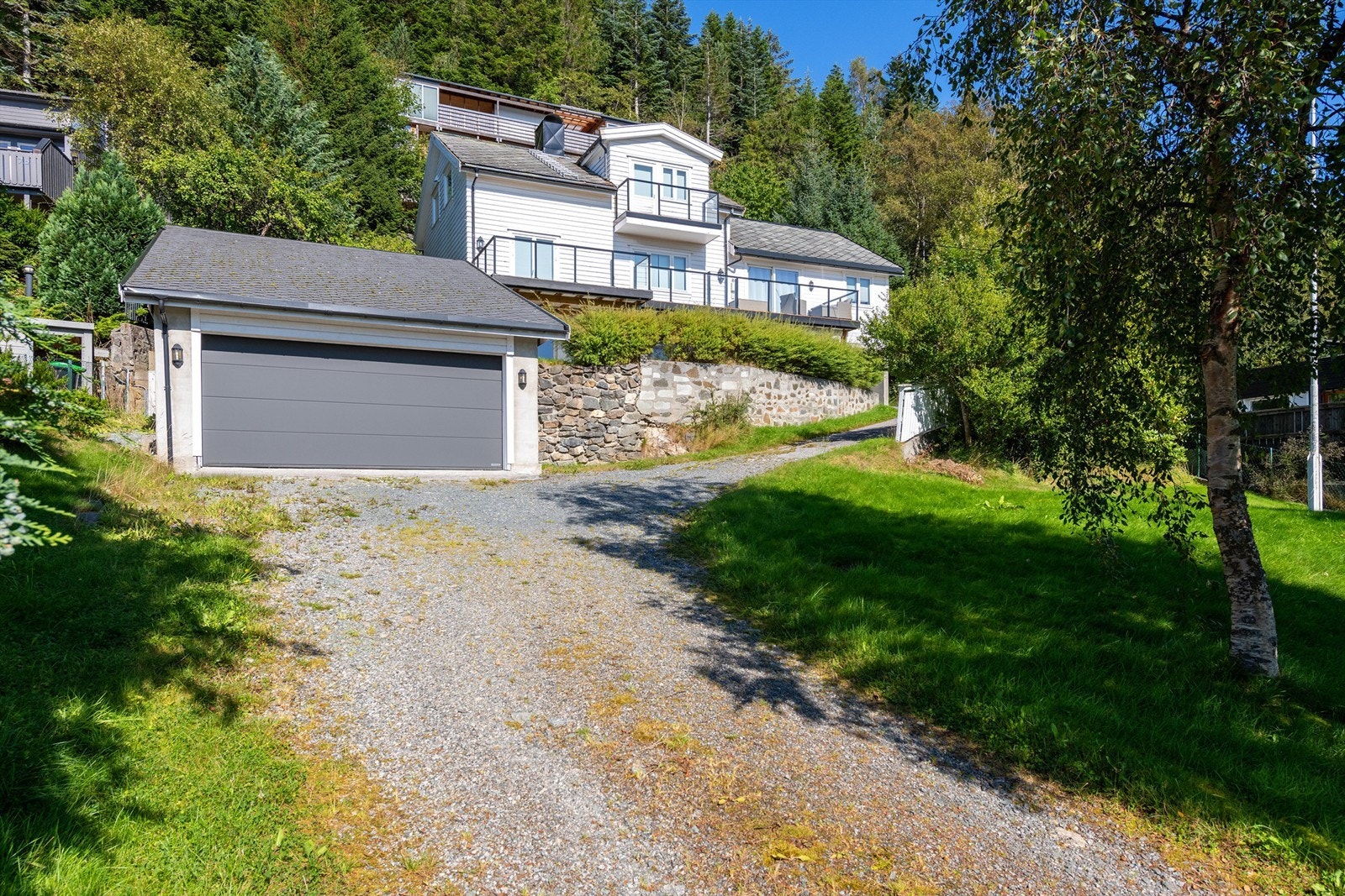 Eiendommen ligger høyt og fritt med bilvei helt opp til huset Galleribilde