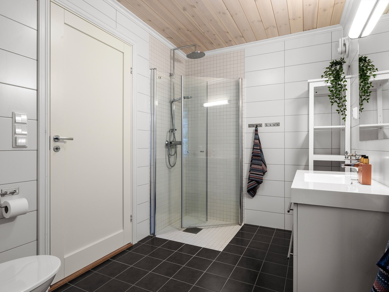 Helfliset bad med dusjhjørne og tidløse detaljer. Vannfallsdusj og håndholdt. Perfekt for avslapning og velvære på hytta. Galleribilde