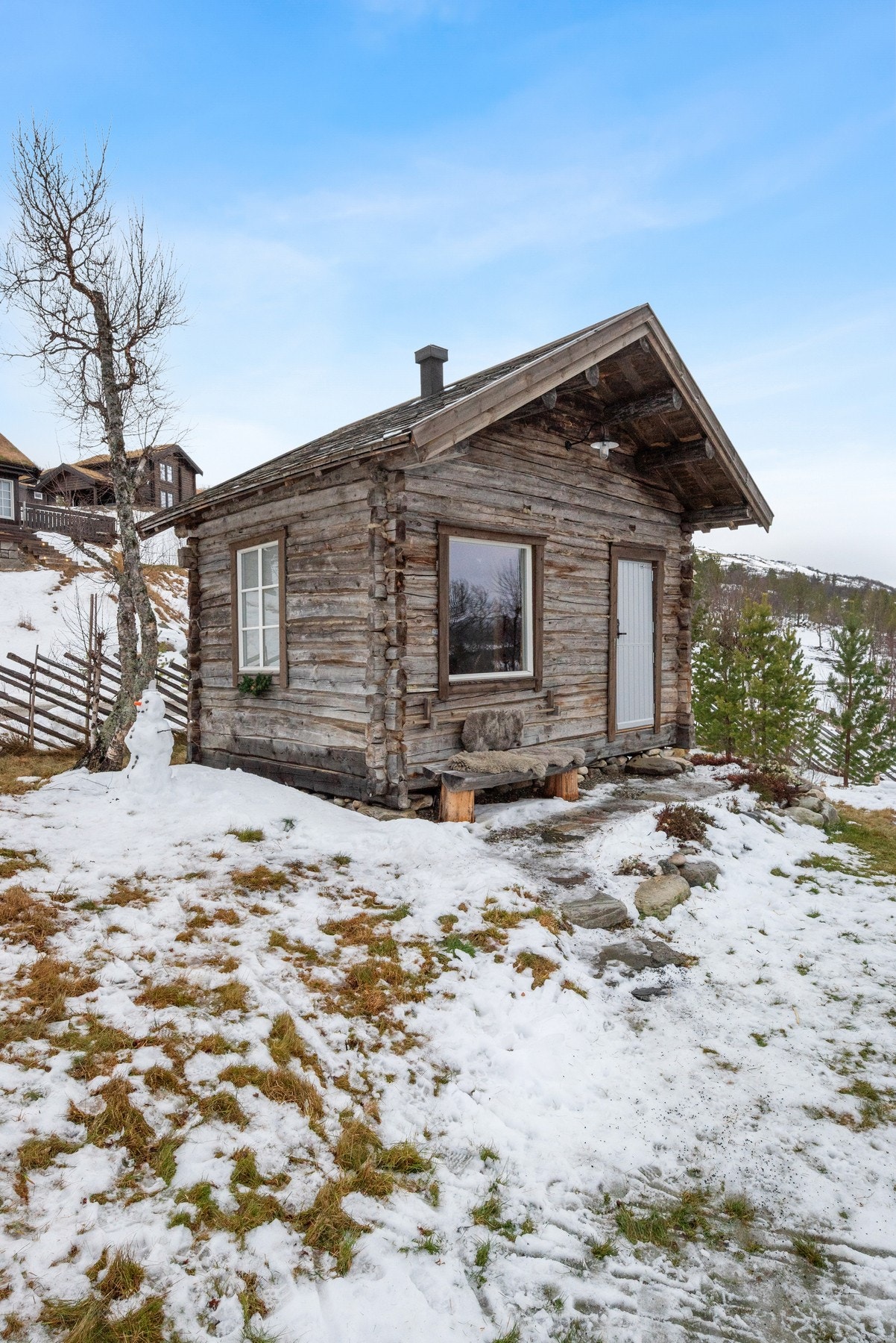 En spasertur over plenen, er det også uthus innredet med badstue, vedbod og lagringsplass. Utenfor er en hyggelig sittebenk med flott utsikt. Galleribilde