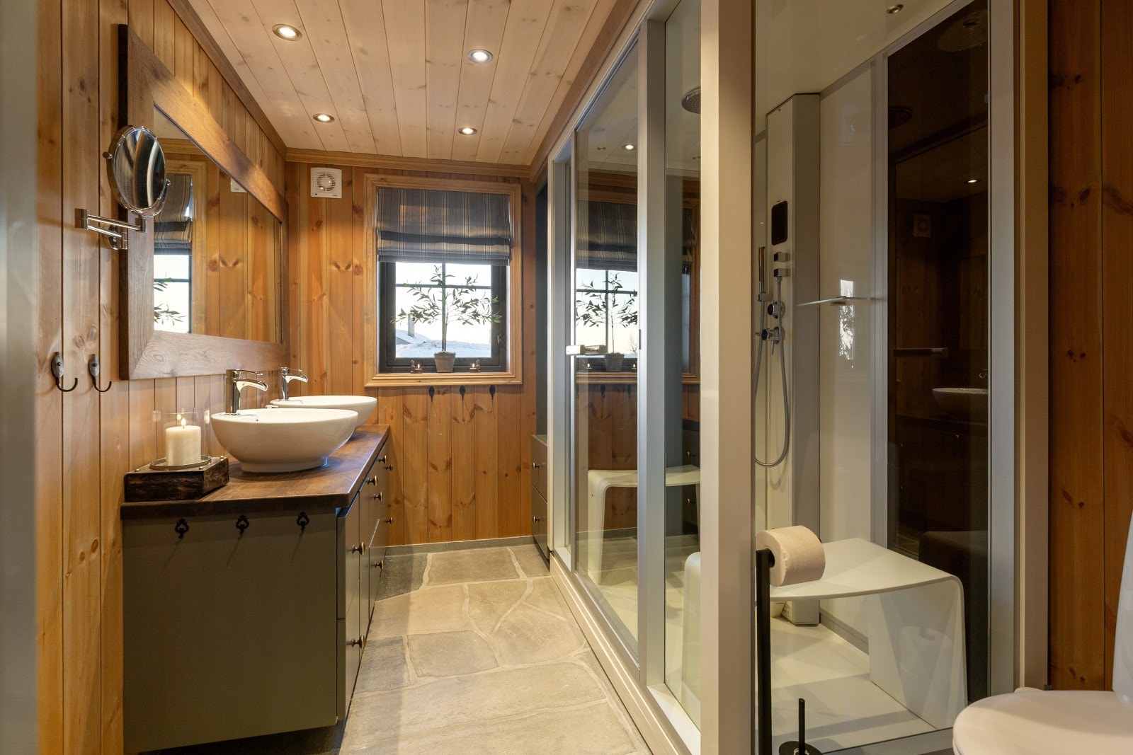 I hytta er det to delikate bad, hvor hovedbadet som er i tilknyttning til hovedsoverommet har baderomsinnredning i heltre, toalett og stort steamdusj-kabinett med glassvegger. Galleribilde