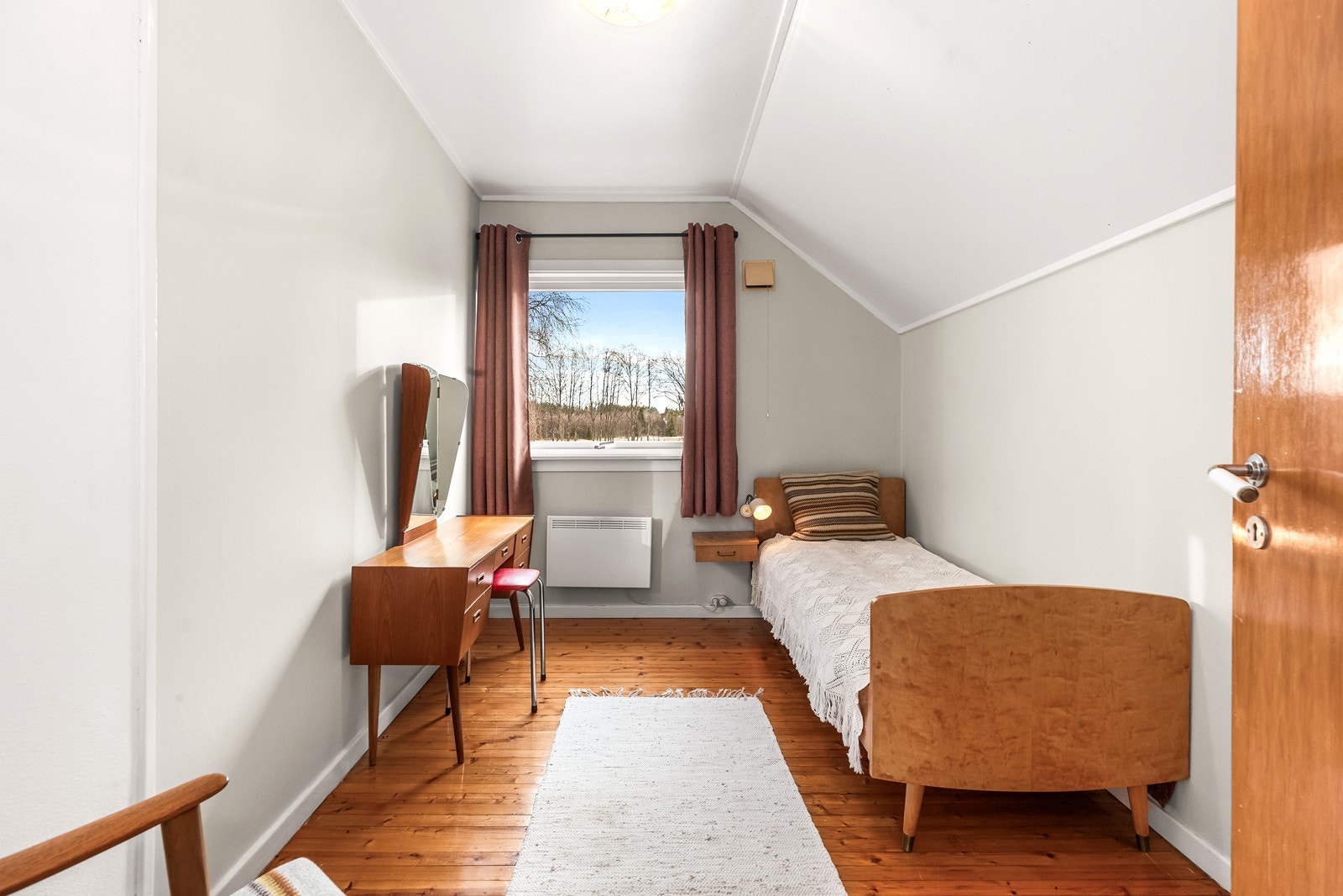 Soverom II er møblert med seng og sminkebord, og har originale tregulv, samt lysmalte overflater. Galleribilde