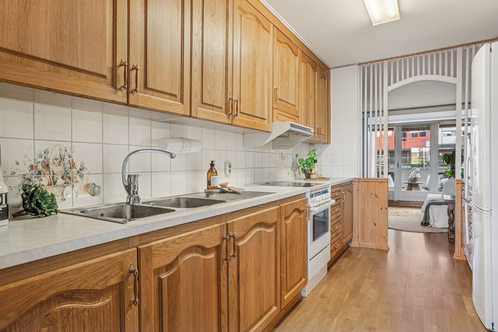 Eldre kjøkken med profilerte fronter og benkeplate av typen laminat. Galleribilde