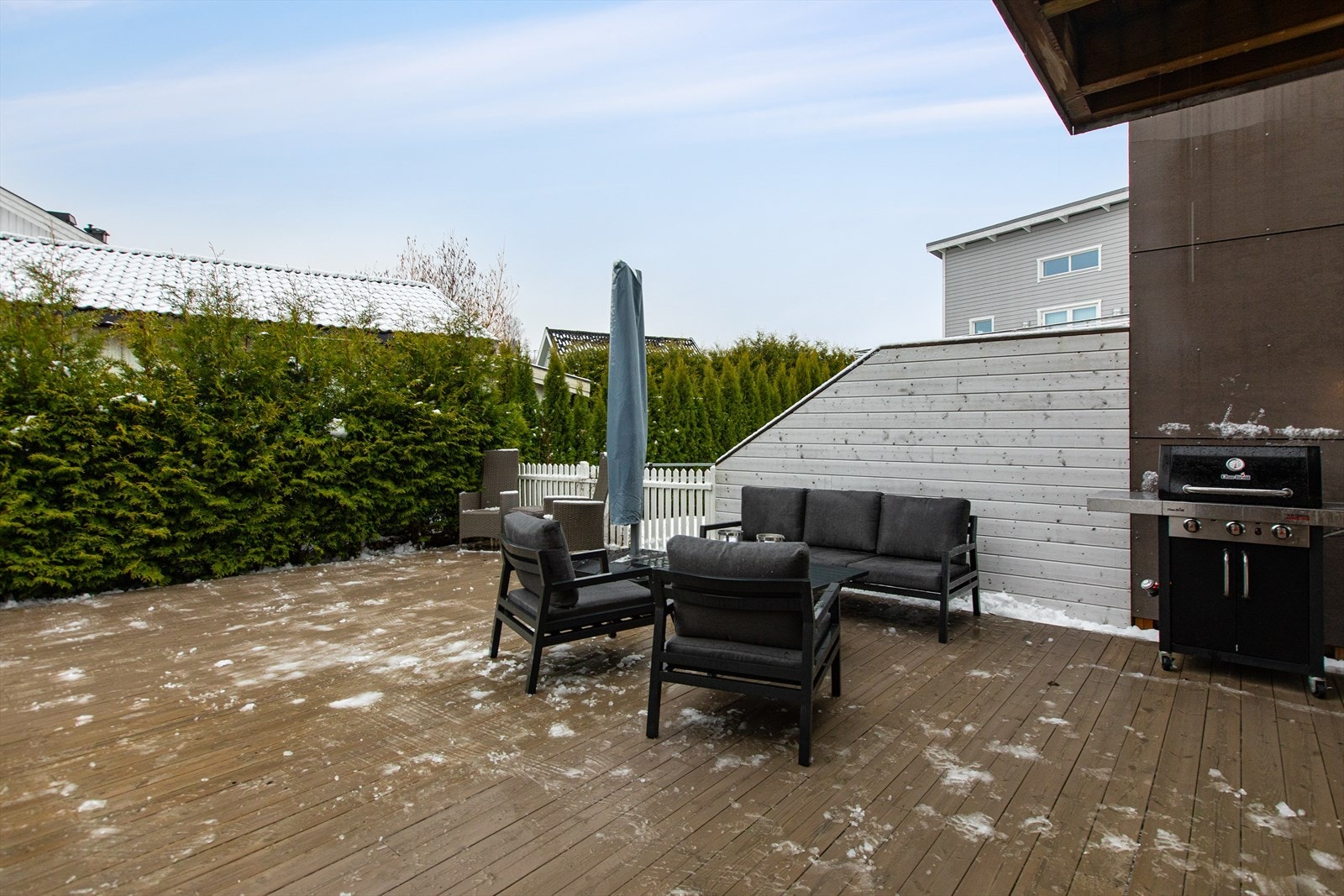 Terrassen er skjermet med hekk og levegger, som skaper en privat og usjenert uteplass. Galleribilde