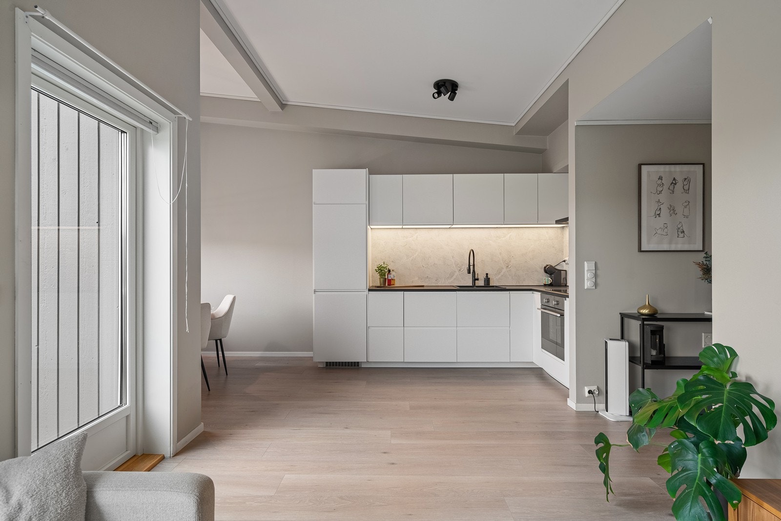 Leiligheten er malt i moderne fargevalg og det er ekstra takhøyde som gir god romfølelse Galleribilde