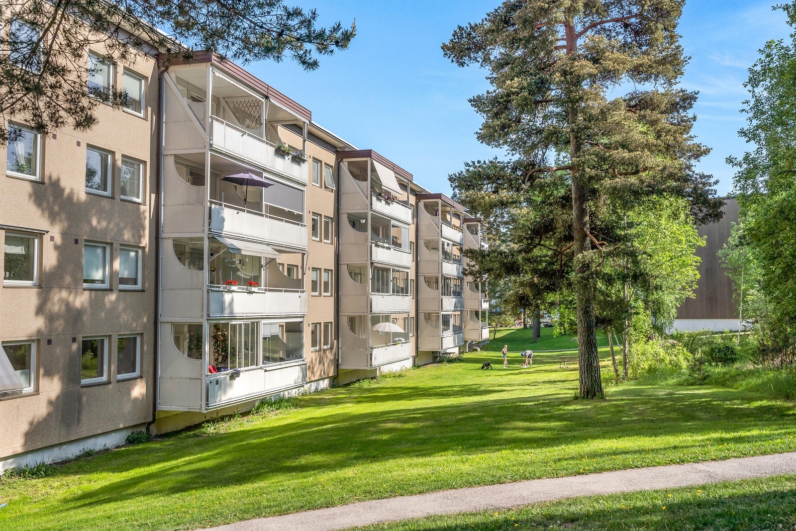 Fine grøntområder rundt bebyggelsen i borettslaget. I området er det gratis gateparkering, og borettslaget har p-plasser som leies ut etter venteliste. Galleribilde
