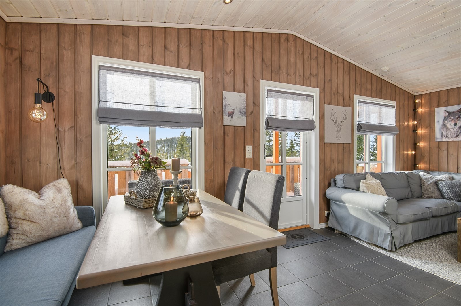 Det kommer fint naturlig lys inn i rommet gjennom store vindusflater. Dør ut til uteplassen fra stua. Galleribilde