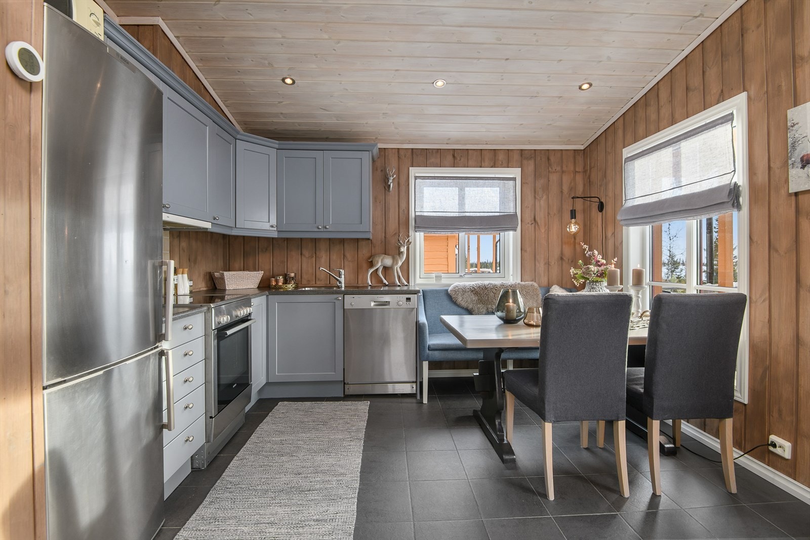 Kjøkkenet er malt i en lun og delikat gråtone. Plass til spisebordet ved kjøkkenet. Galleribilde