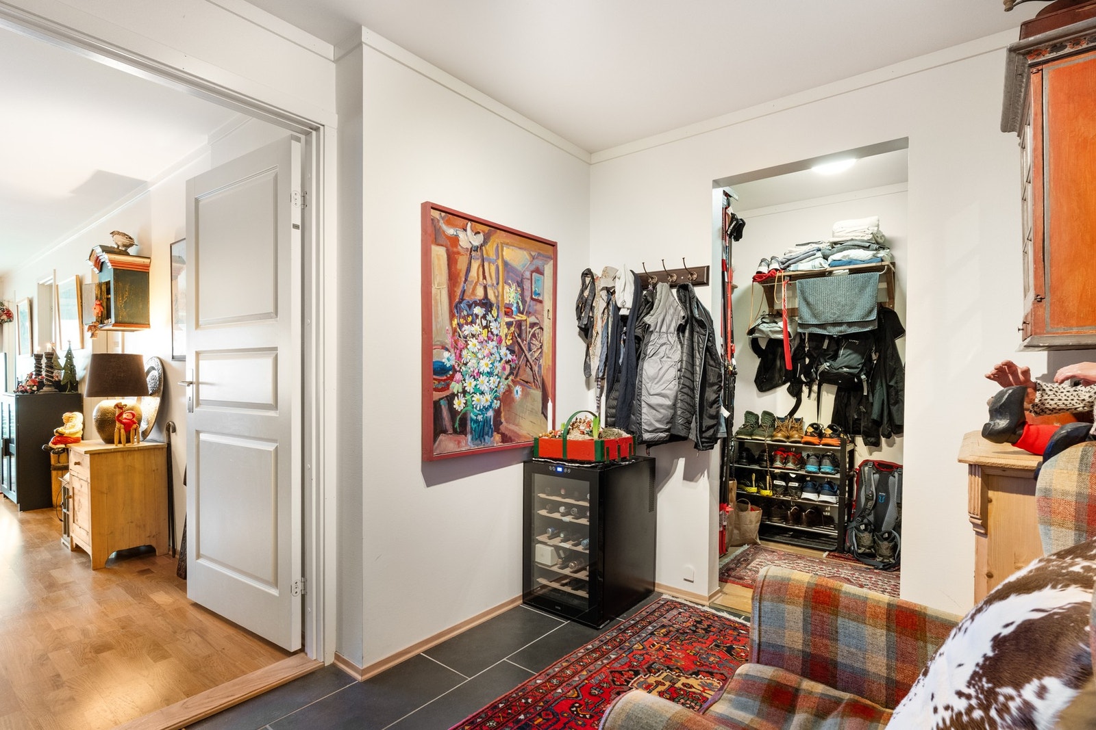 Leiligheten har en lys og innbydende entré som gir et godt førsteinntrykk av leiligheten. Entréen har mørke fliser på gulv, kombinert med lysmalte tak- og veggflater. Galleribilde