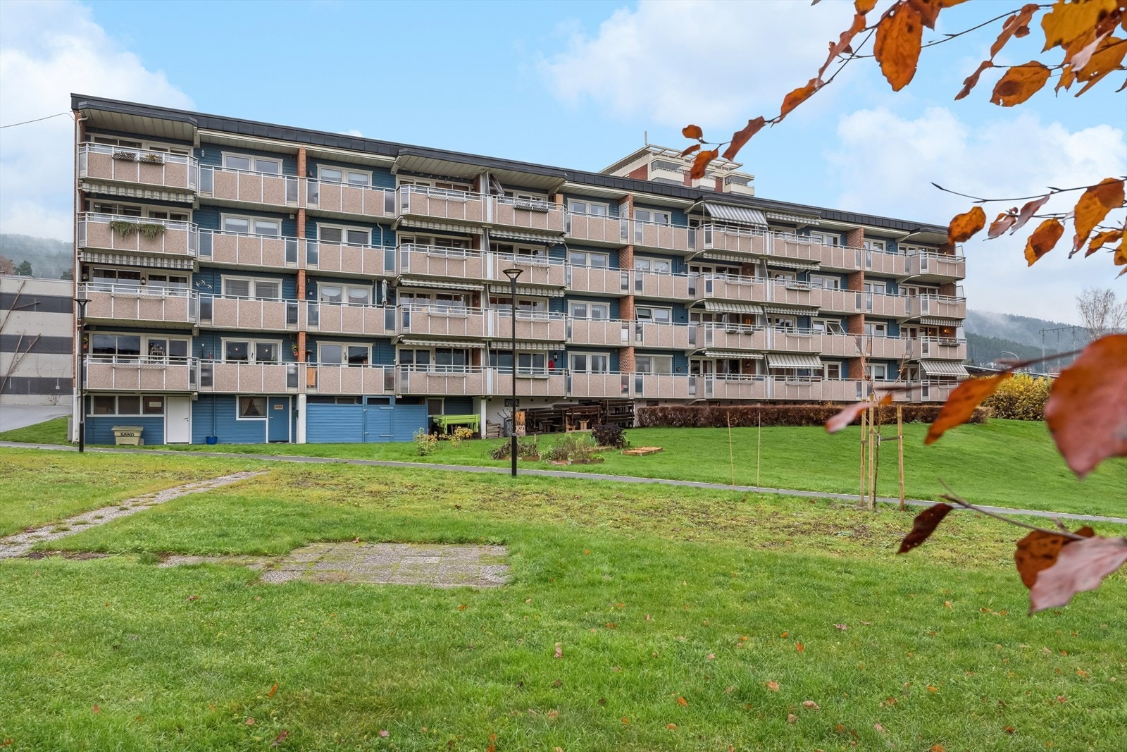 Opparbeidet fellesareal med asfalterte gangveien, gressplen og beplantning. Parkering i felles parkeringshus. Galleribilde