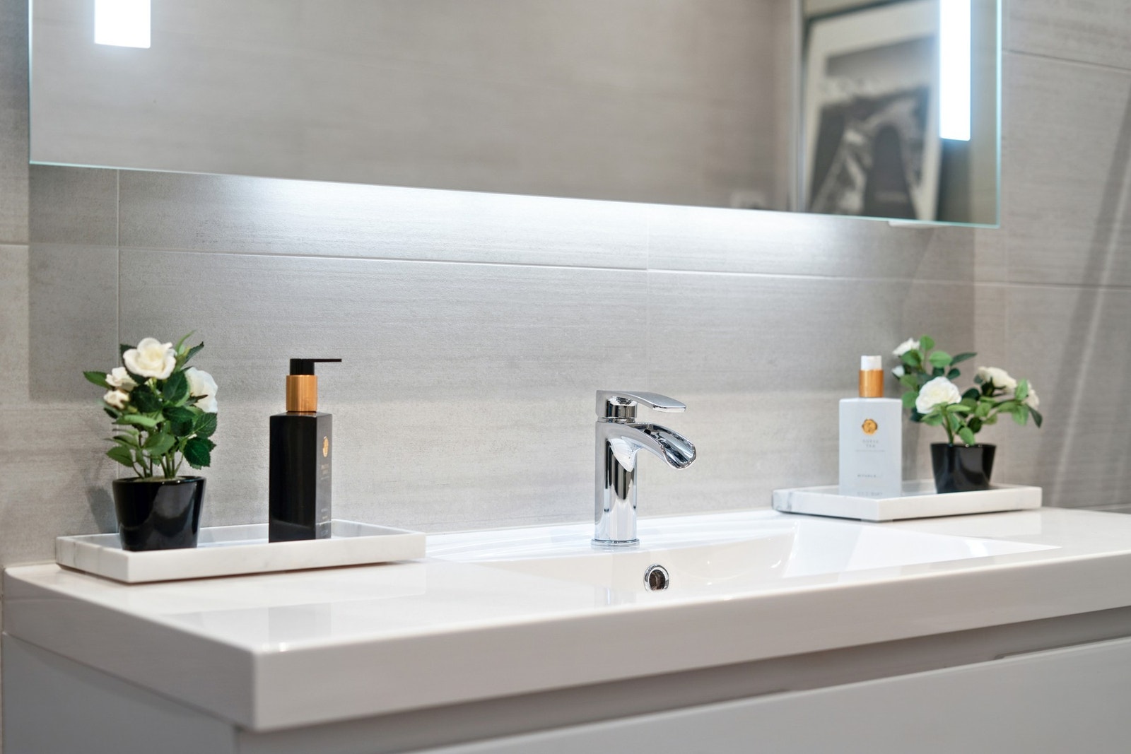 Innredning med heldekkende servant og speil med integrert sminkelys. Galleribilde