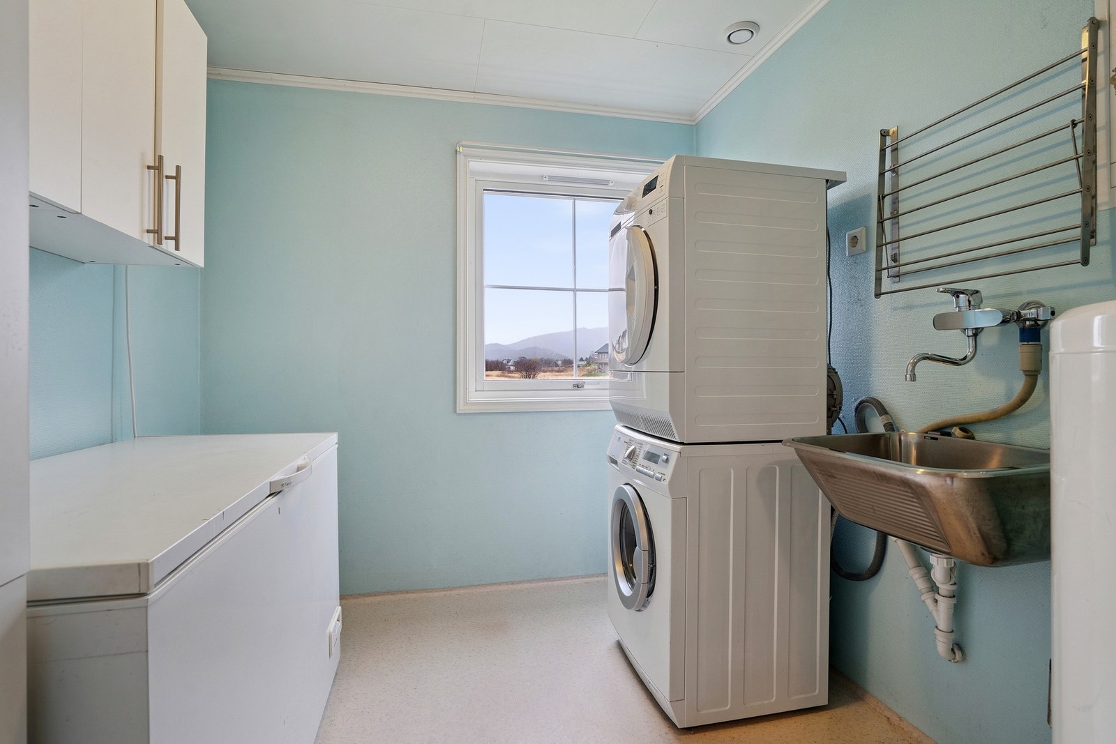 Stort og separat vaskerom er noe man vil sette pris på! Utslagsvask og opplegg for vaskemaskin, samt enkel innredning. Galleribilde