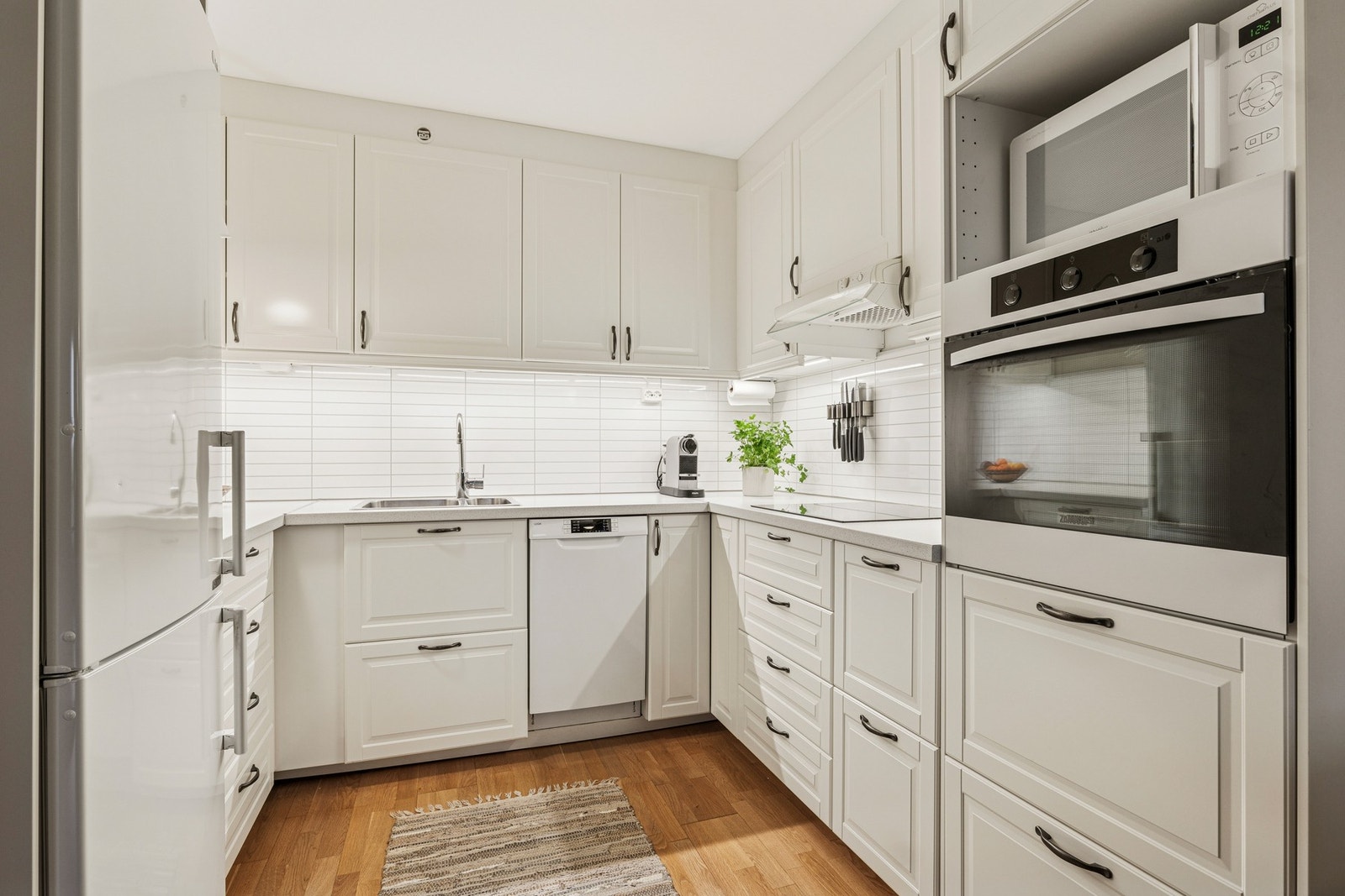 Kjøkkenet er lyst profilert og har integrerte hvitevarer som medfølger i handelen. Galleribilde