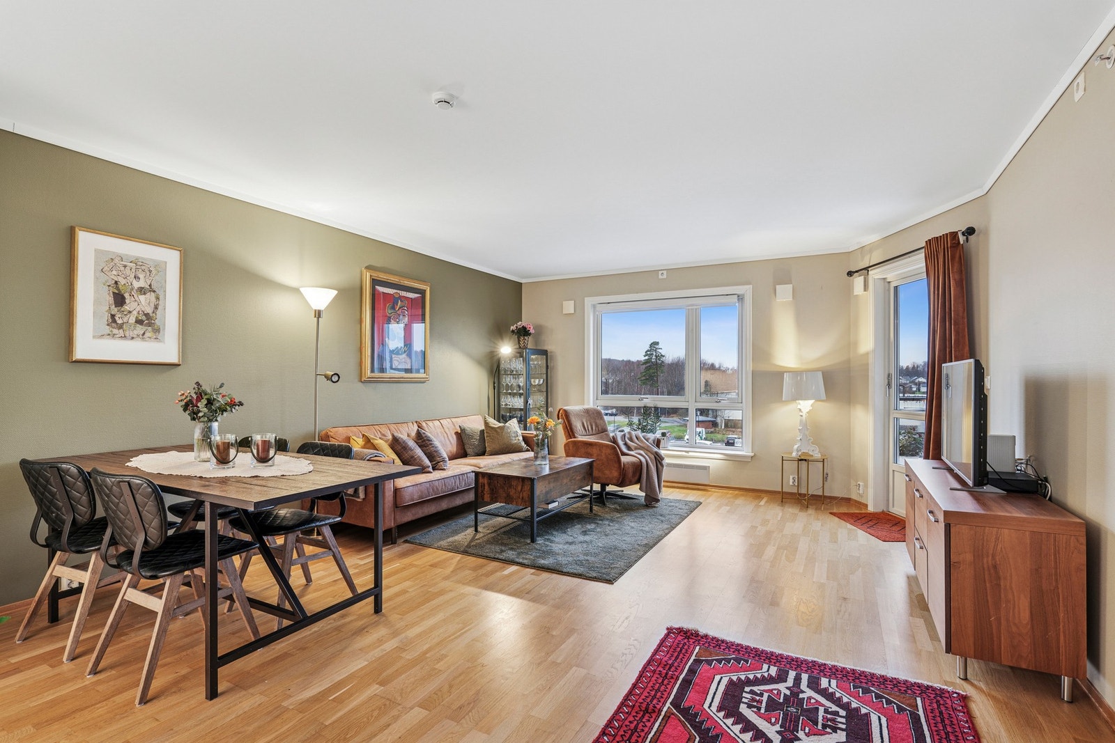 Lys og romslig stue med store vinduer som gir godt med naturlig lys. Galleribilde