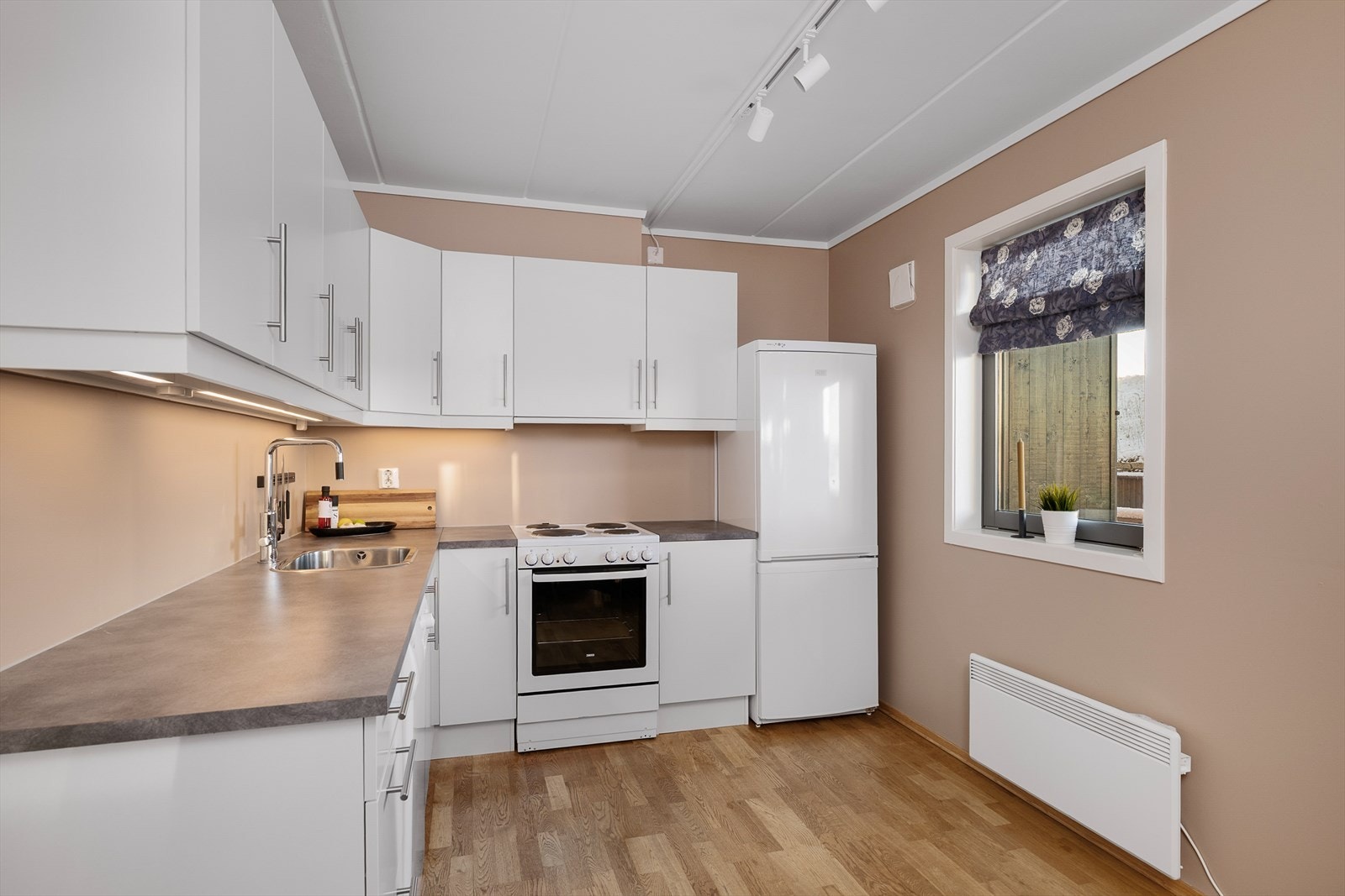 Kjøkkeninnredningen er utvidet med ekstra overskap, som gir rikelig med lagringsplass. Galleribilde