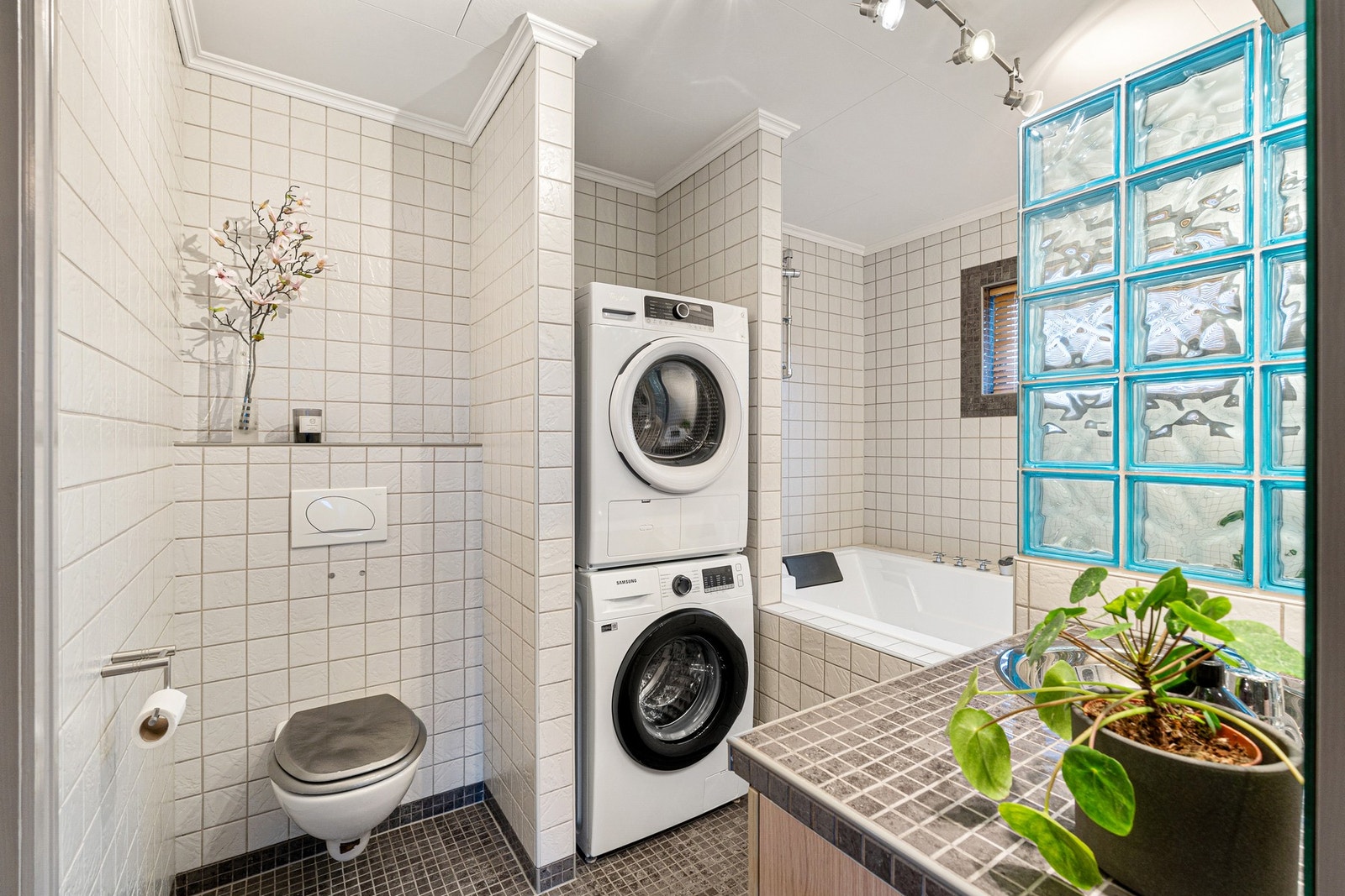 Flott flislagt bad med egen nisje for vaskemaskin. Galleribilde