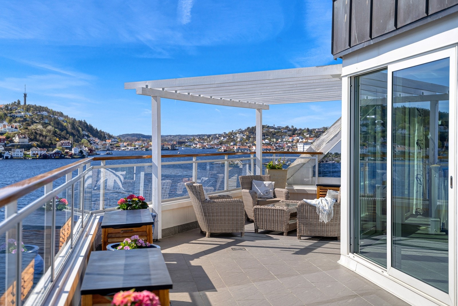 Terrassen har glassrekkverk som sikrer at utsikten ikke blir blokkert og er innredet med et maritimt preg som speiler områdets båt- og sjøliv. Galleribilde