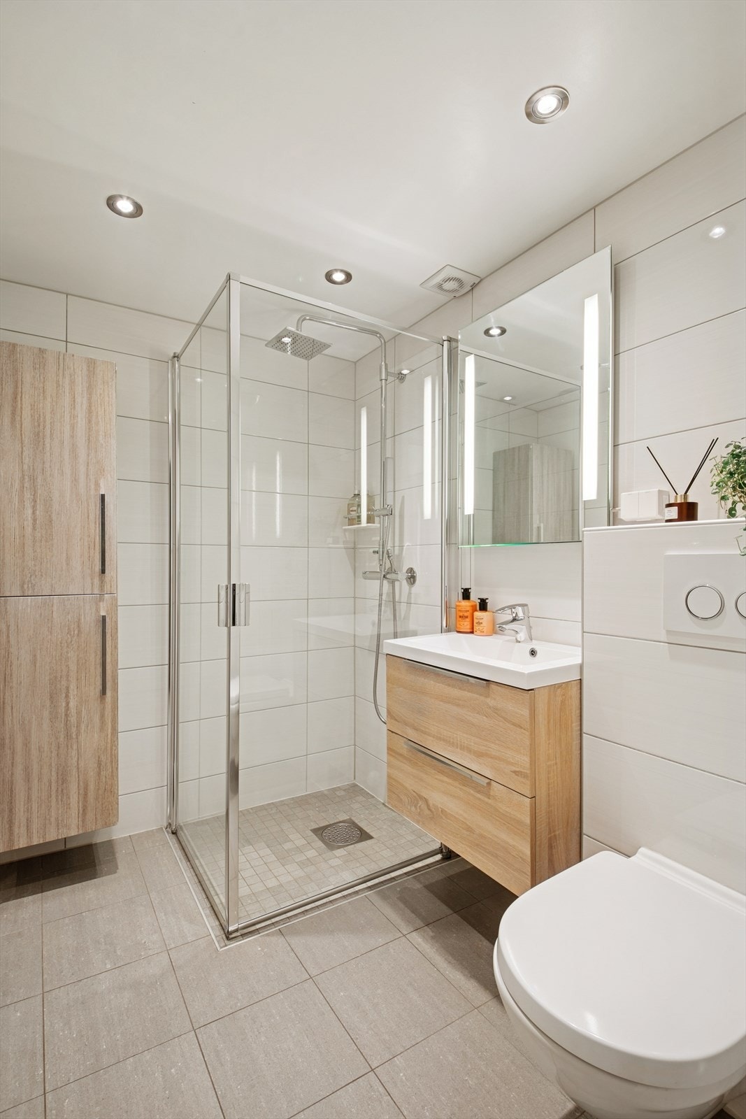 Badet er ellers utstyrt med dusjhjørne, vegghengt toalett og baderomsinnredning med nedfelt servant. Galleribilde